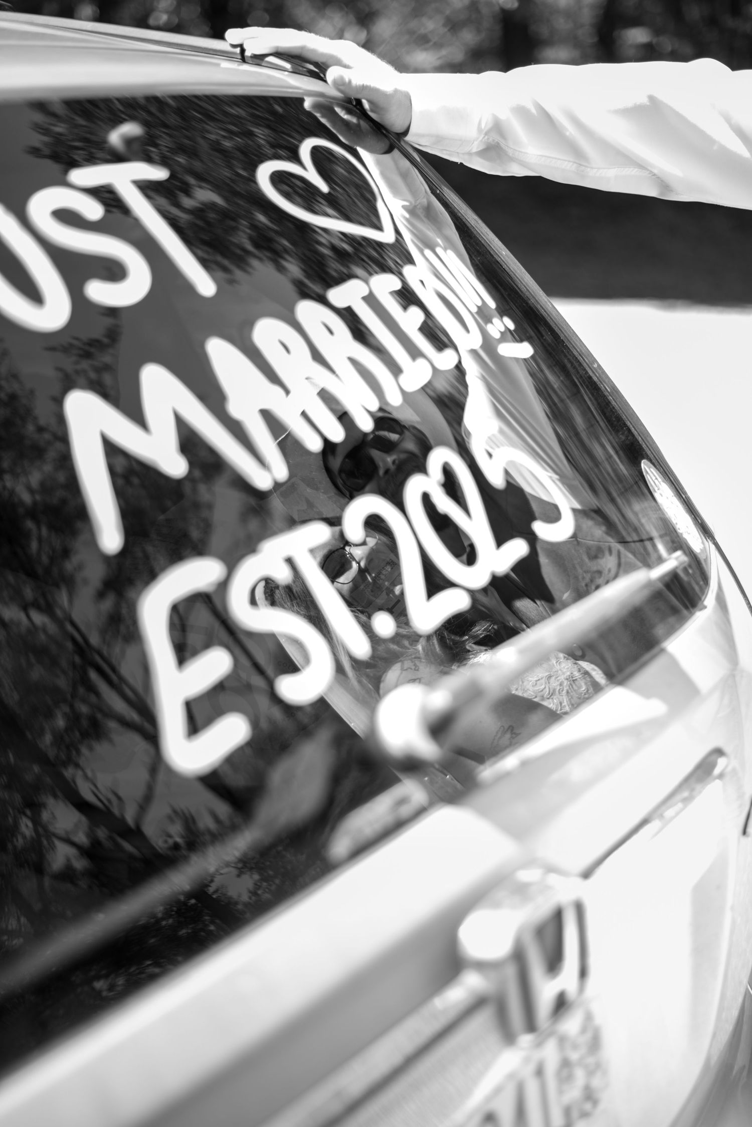 Black and white detail shots of writing on a car window.