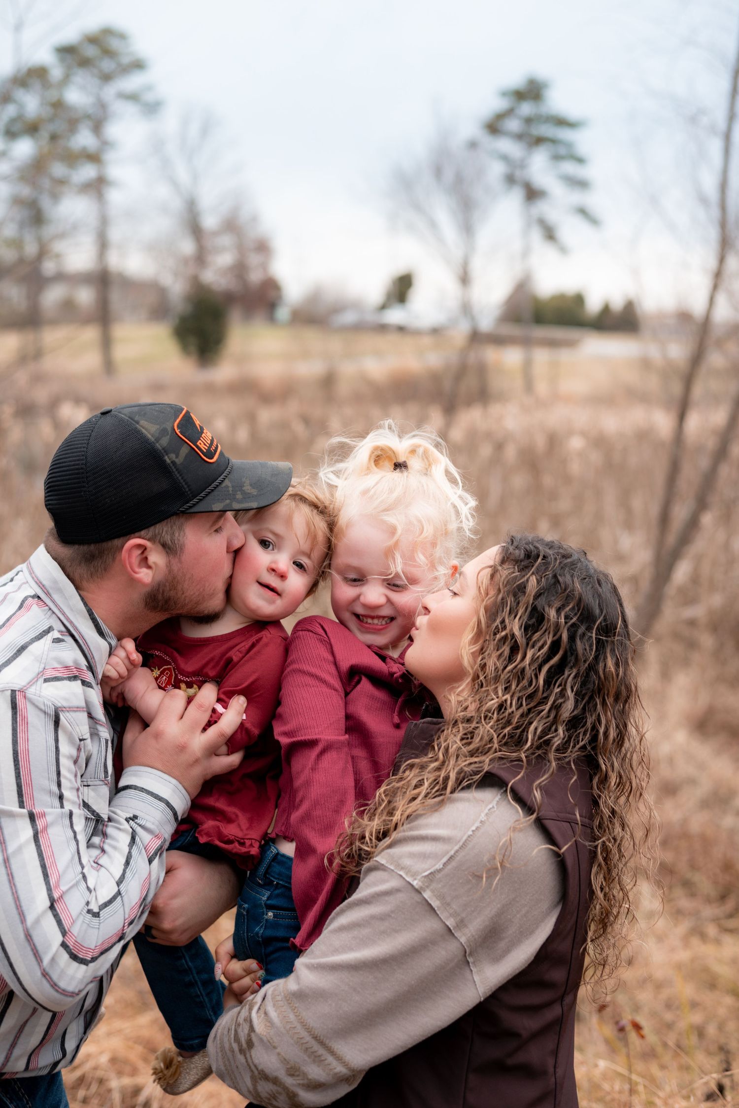 Candid family moments showing affection and laughter in an autumn field setting.