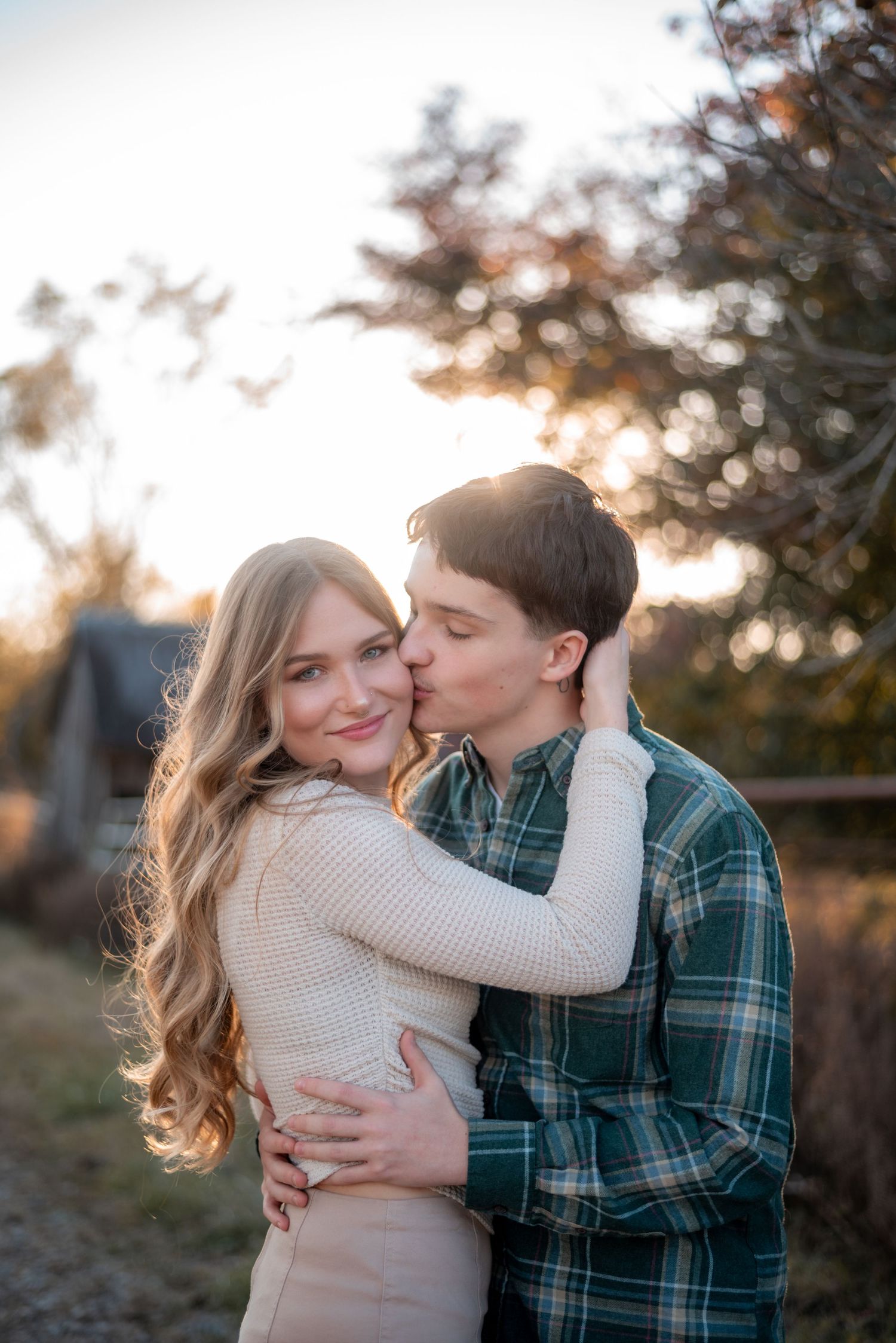 A couple shares intimate moments during a golden hour photo session.