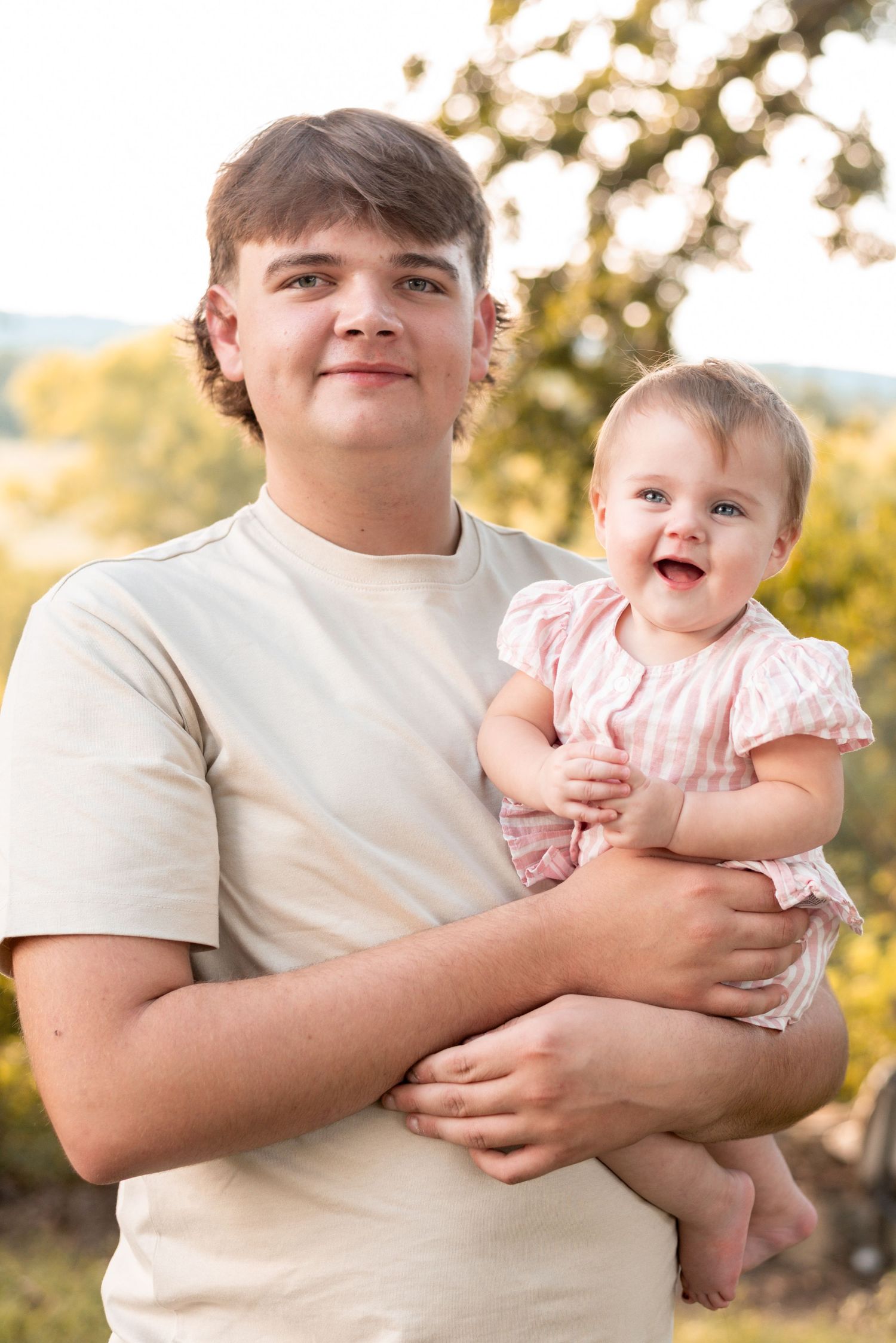 Candid moments between family members during outdoor portrait session.