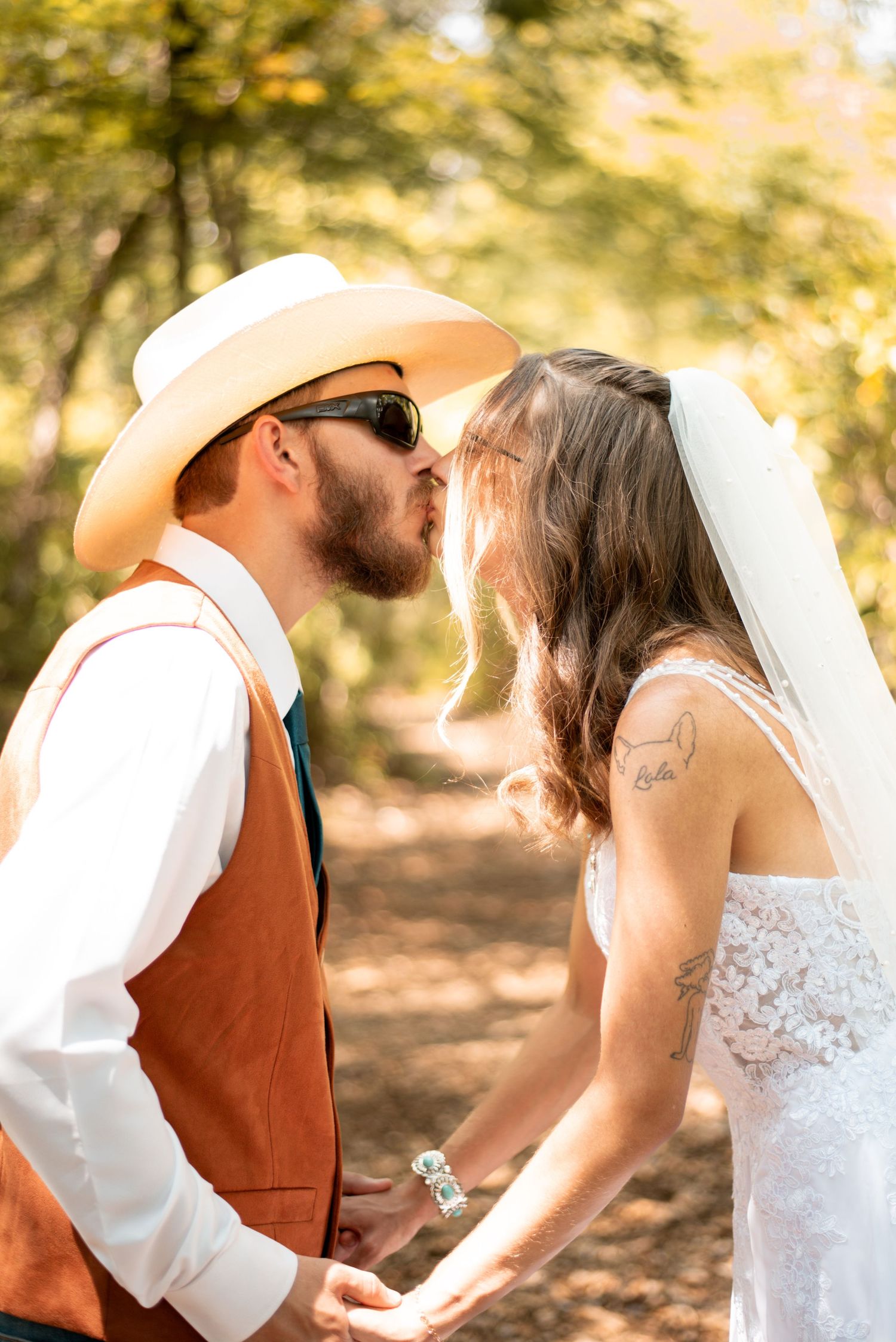 A romantic wedding photo series showing a couple in a white dress and brown vest embracing in golden sunlight.