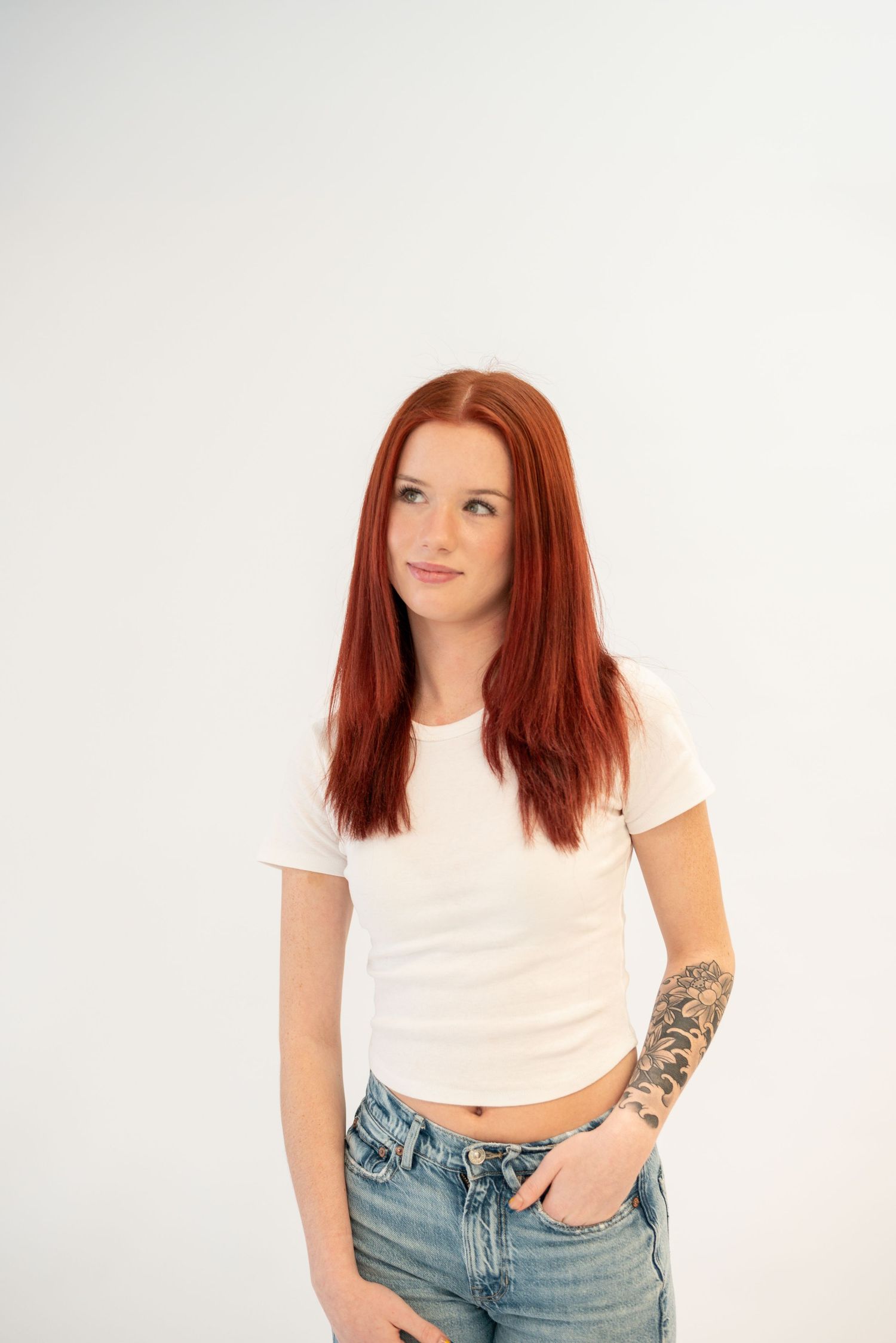 Studio fashion portraits featuring casual style with white top and blue jeans.