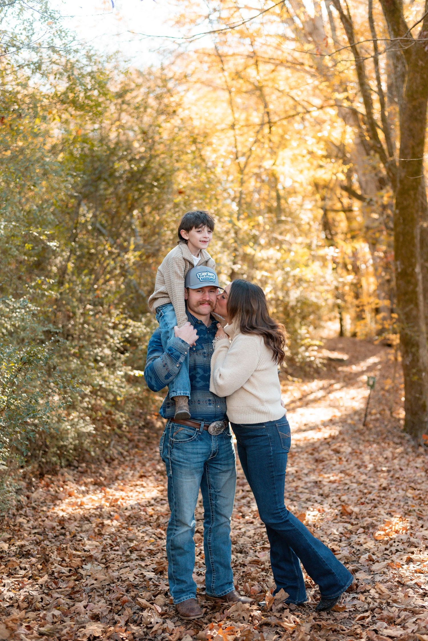 Romantic couple photos in casual wear among fallen autumn leaves.