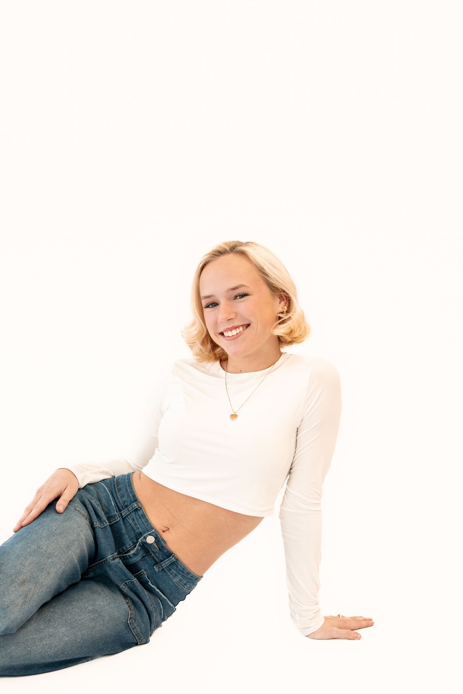 Artistic white studio shots featuring relaxed poses in casual attire.