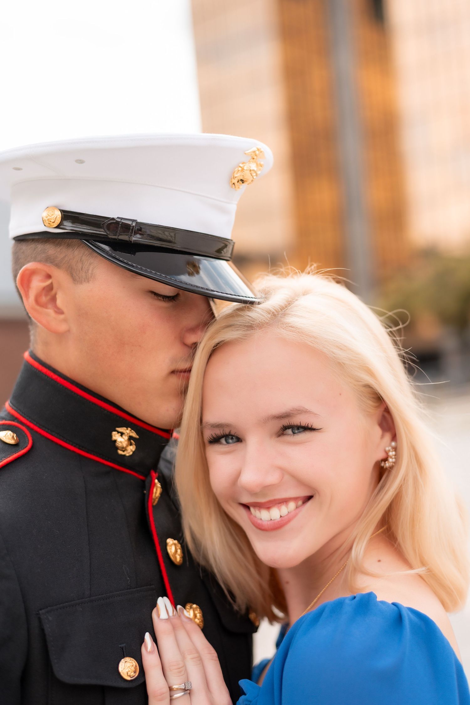 Military engagement photos showing couple in formal dress uniform and blue outfit.
