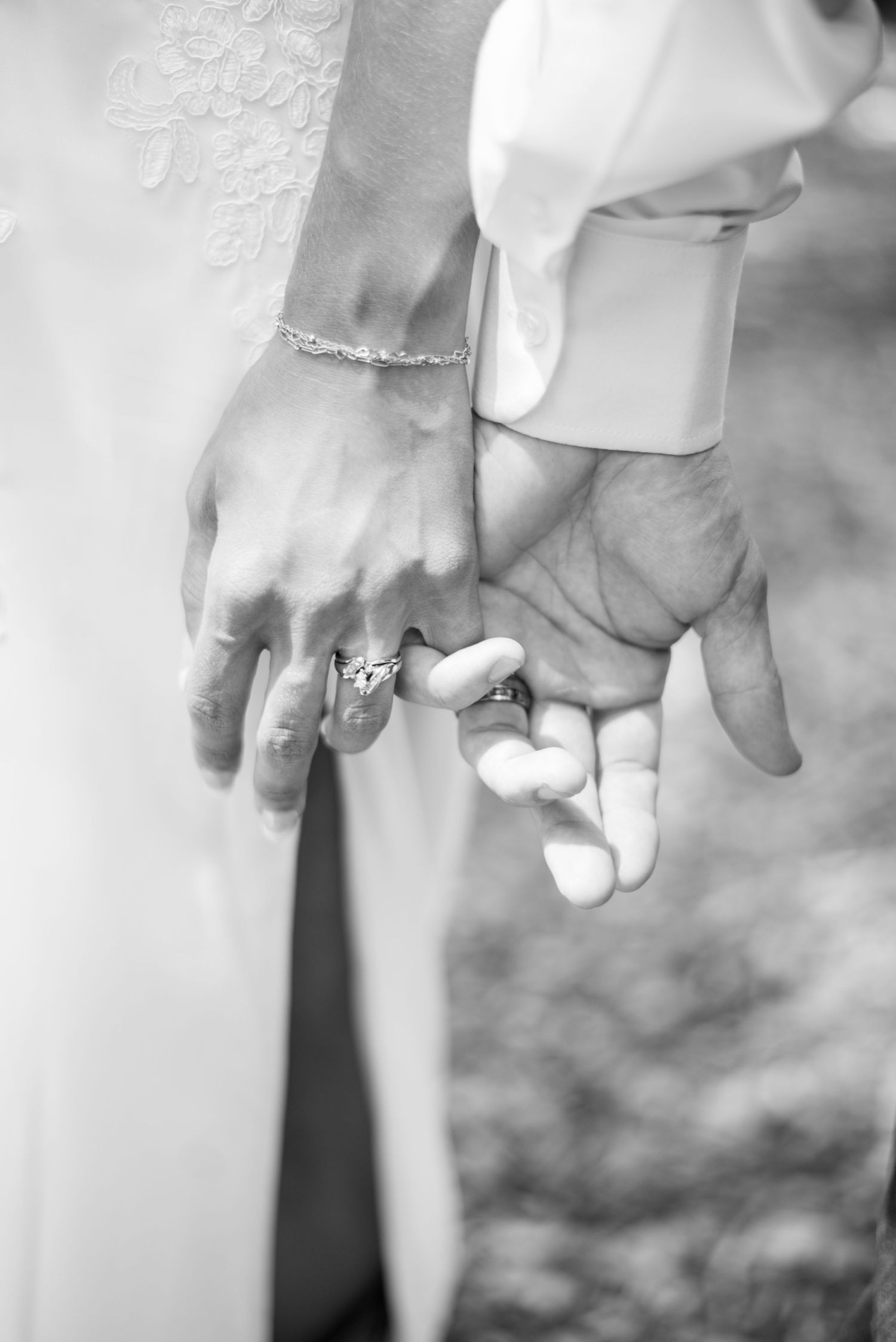 Black and white close-up series of hands holding together showing wedding rings.