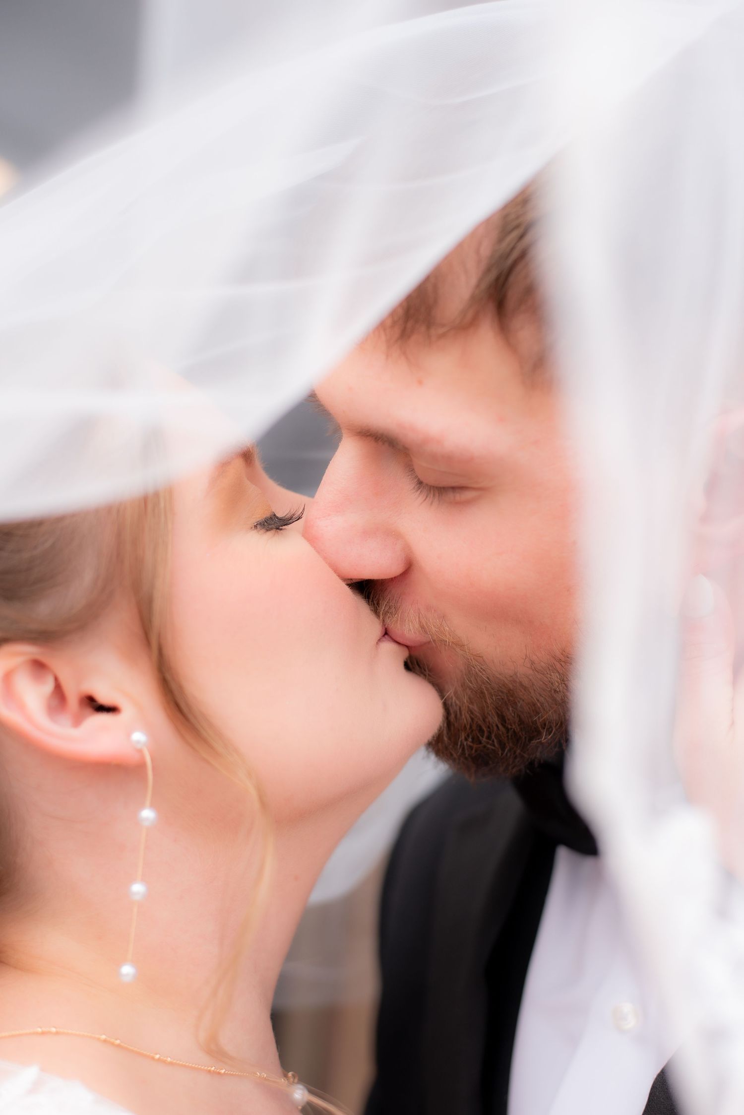 Romantic wedding veil shot with soft focus and dreamy lighting.