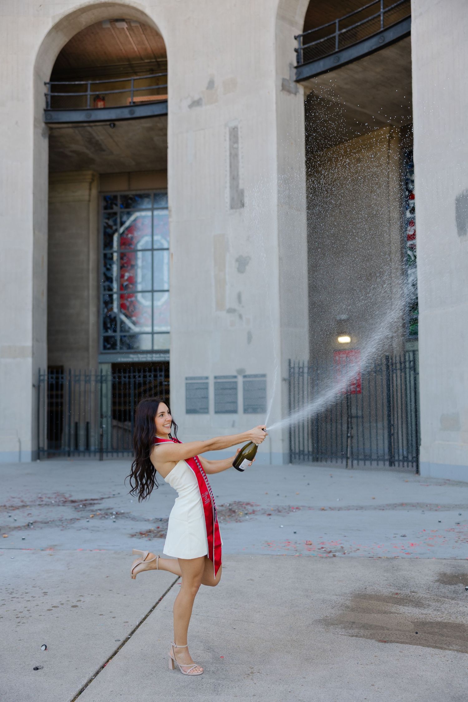 Columbus photographer capturing Ohio State senior session. Champagne spray