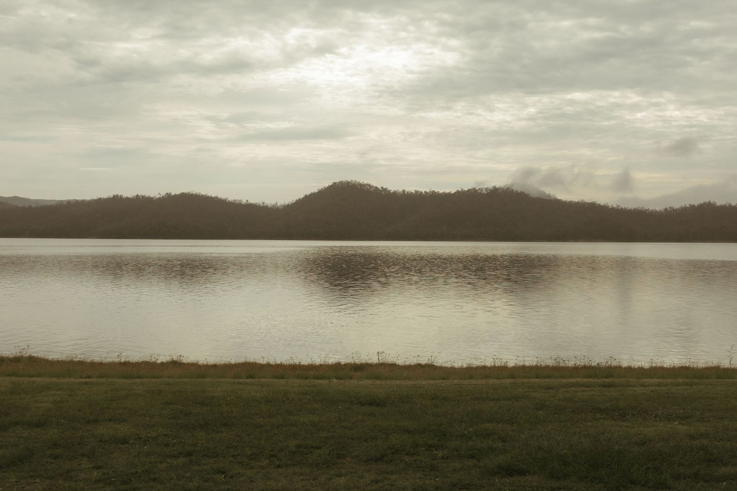 Quiet lake at dawn
Calm lake and mountains at sunrise during atmospheric nature photography in South East Queensland.