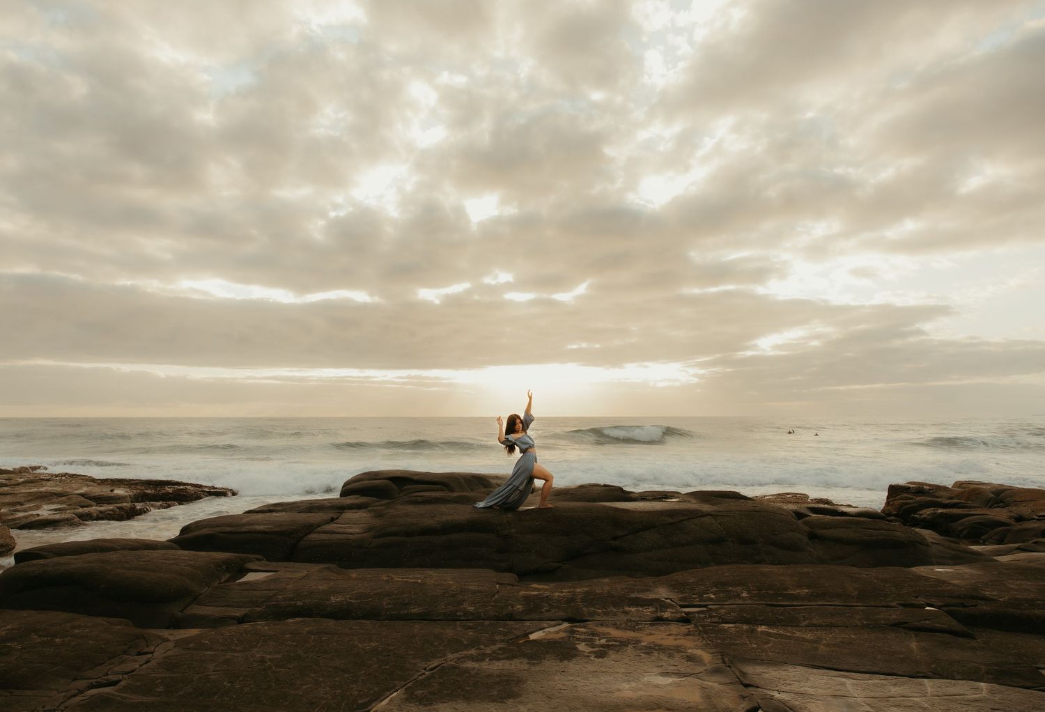 Woman dancing on rocks
Woman dancing on coastal rocks at sunrise during a creative session on the Sunshine Coast.