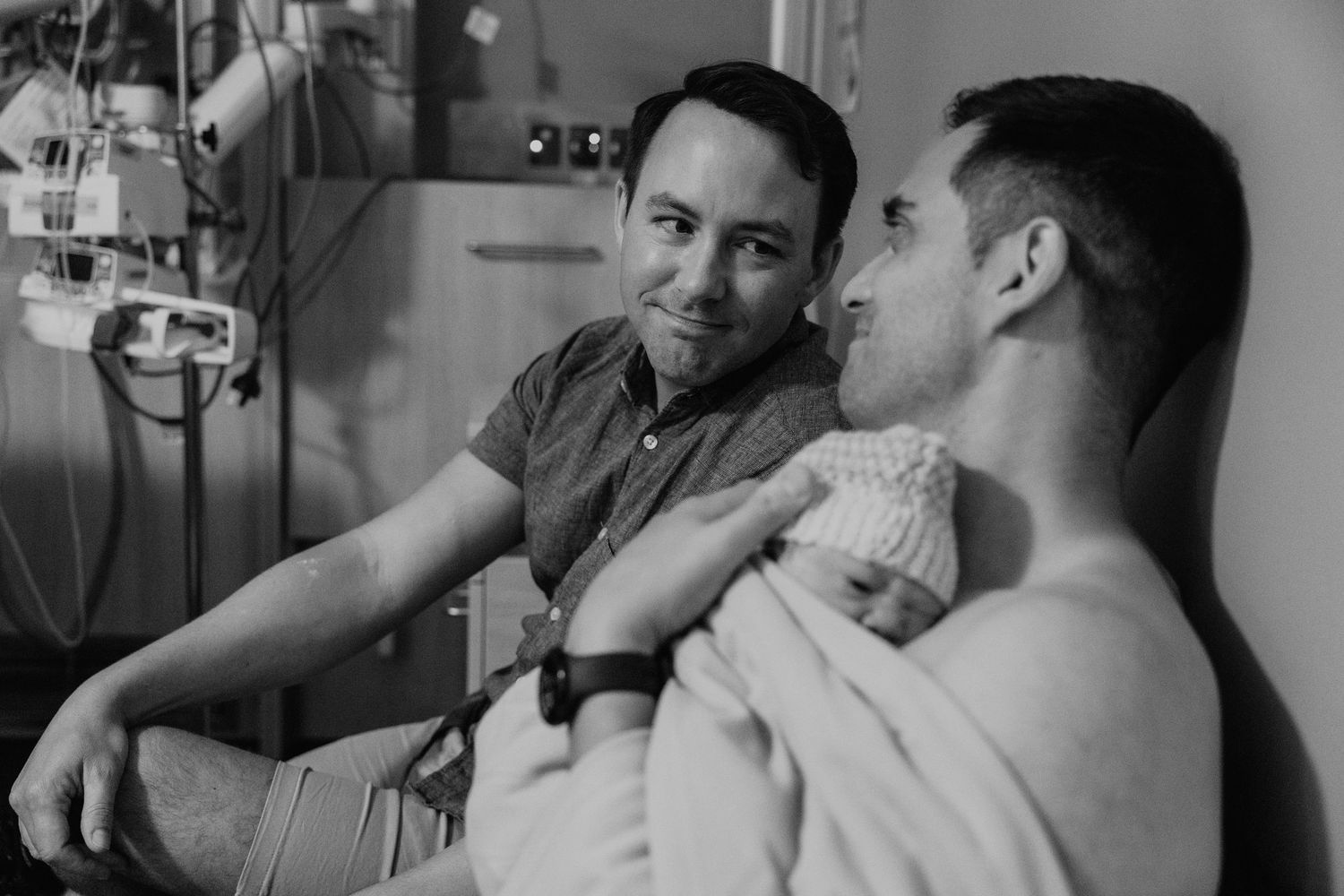 Dads meeting newborn in hospital
Two fathers holding their newborn in a tender hospital moment during Brisbane birth photography. Surrogacy.