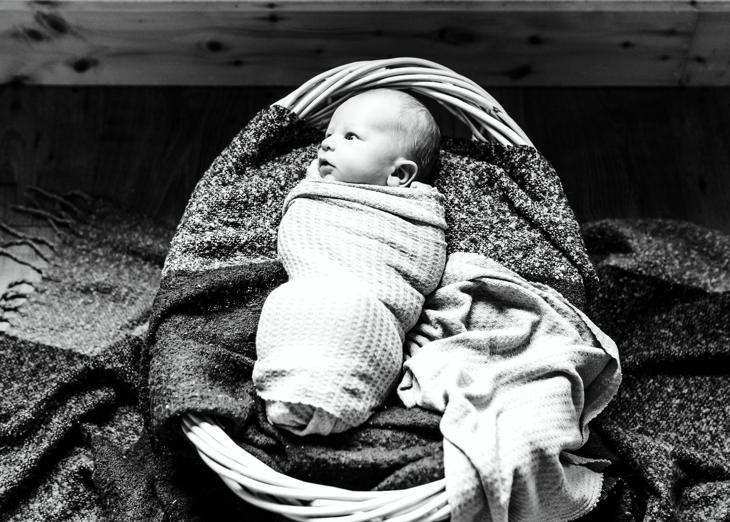 A series of black and white photos showing someone resting on a blanket in different positions.