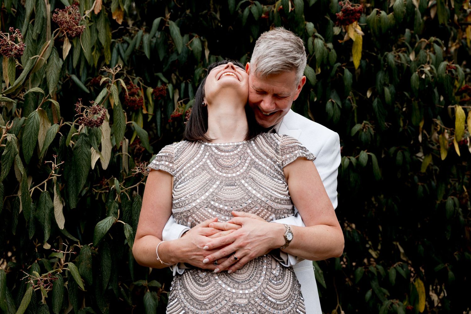 Outdoor wedding portraits with natural foliage backdrop in summer garden setting.