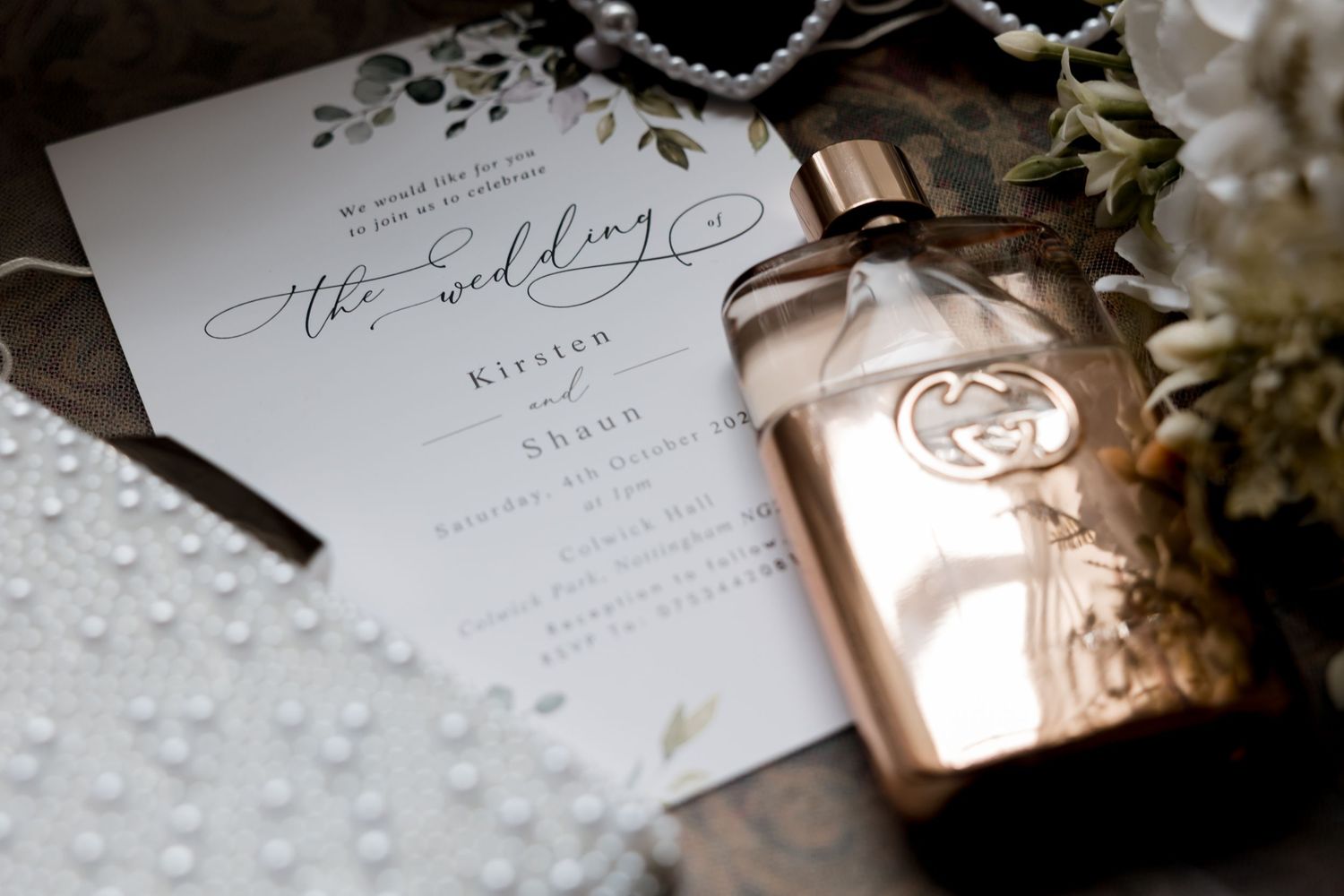 Wedding stationery and invitations with delicate pearl details and floral accents.