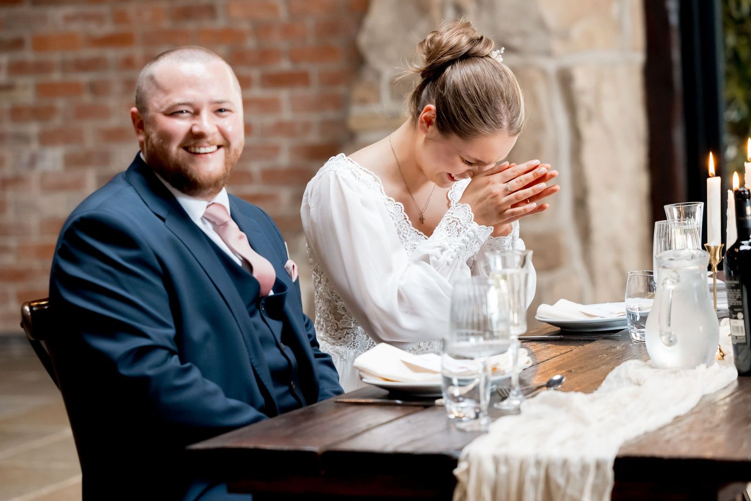 Candid moments of joy and laughter shared during a wedding reception dinner.