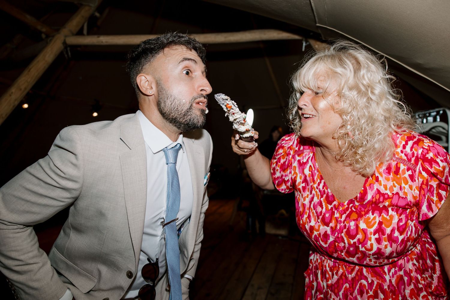 Lively dance floor moments at wedding reception with guests in formal attire.