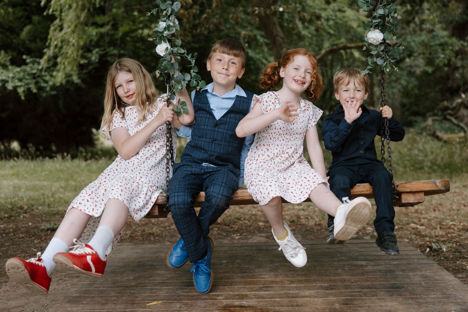Family members sitting casually on wooden bench showing playful feet.