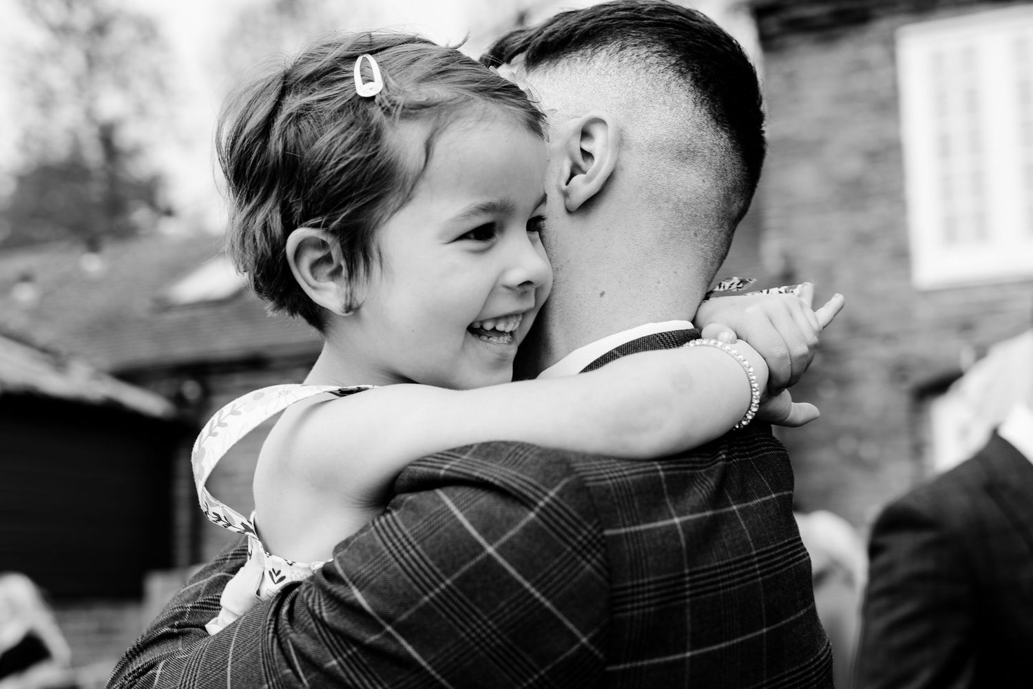 Black and white wedding photos showing tender moments between a couple at their celebration.