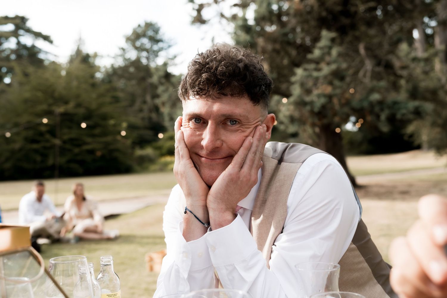 Candid wedding celebration moments captured in natural outdoor setting.