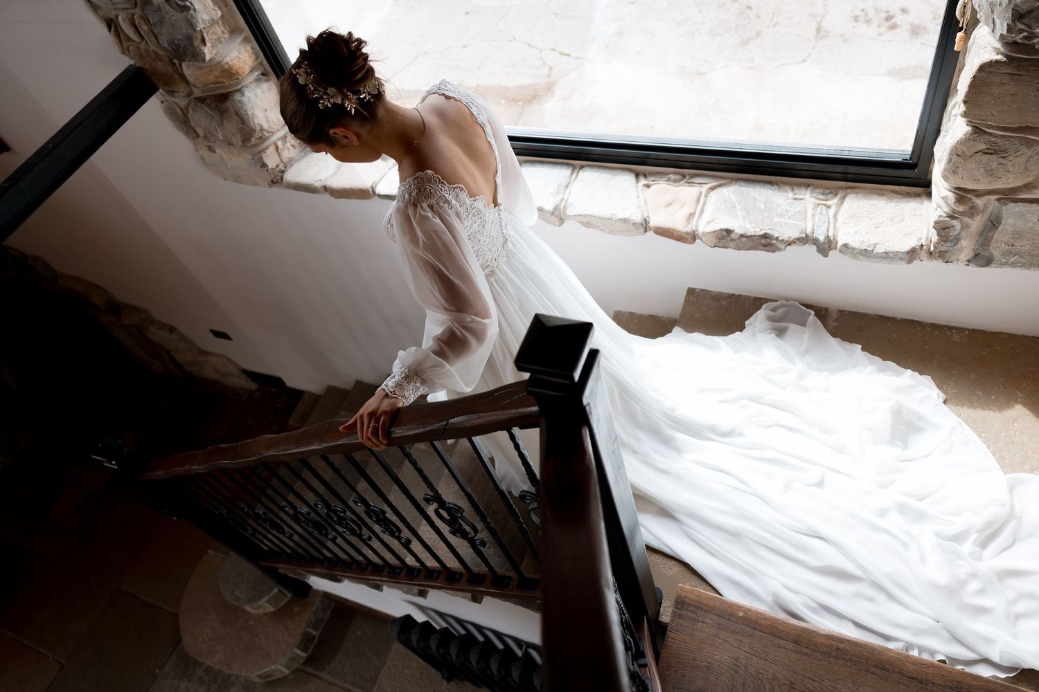 Wedding dress being prepared and steamed before the ceremony in a sunlit room.