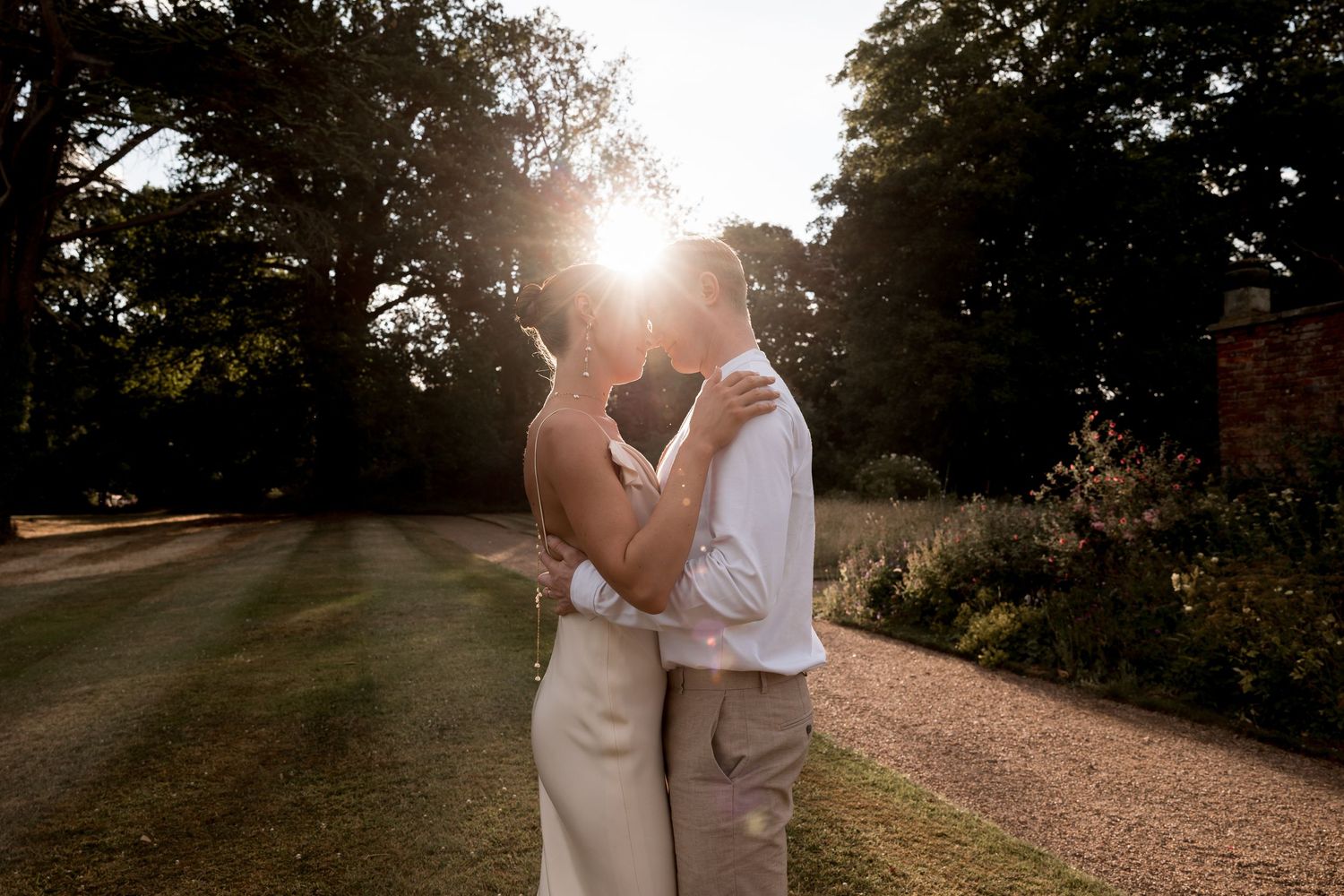 Romantic sunset photoshoot in a garden setting with soft golden light.