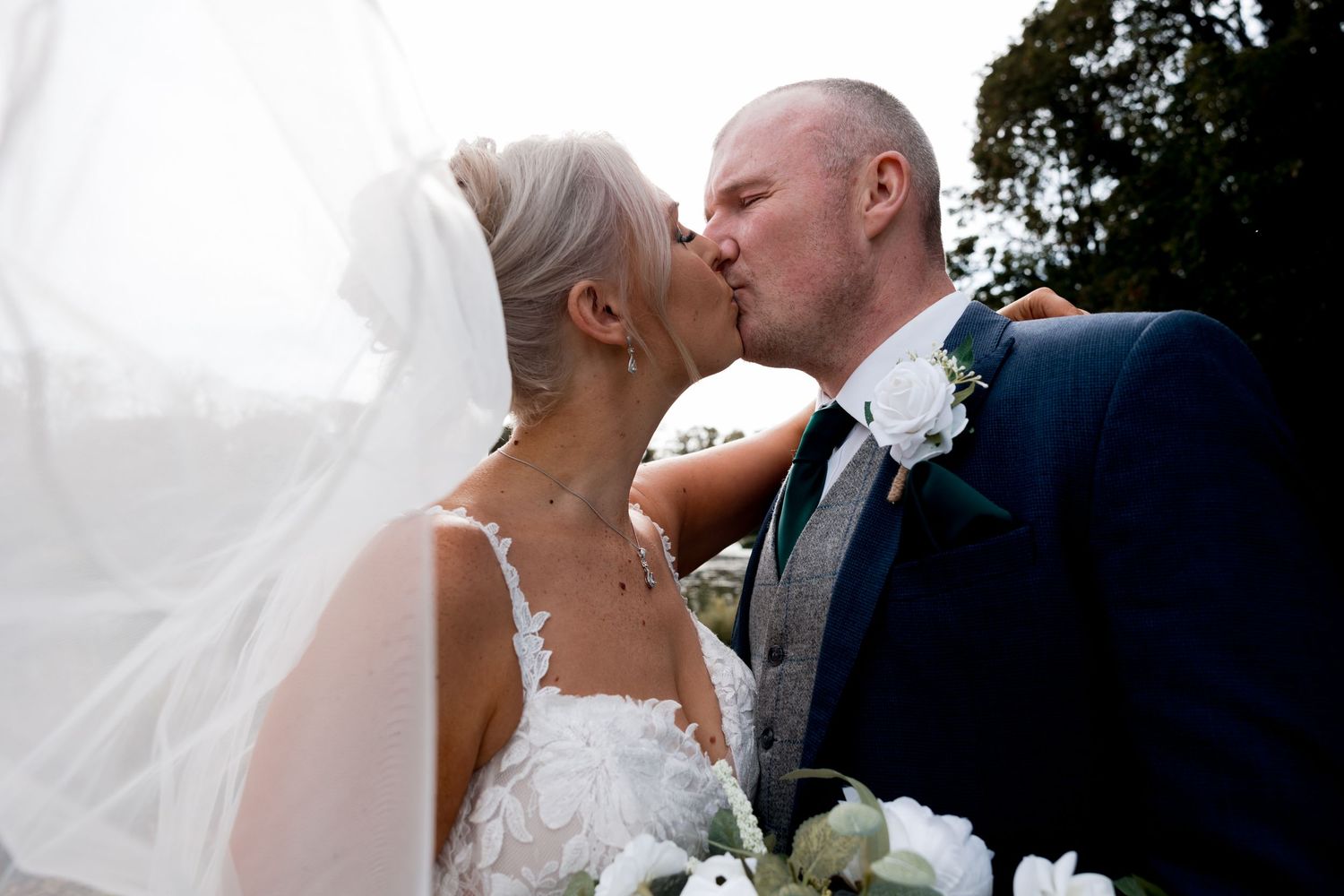 Romantic outdoor wedding portraits against natural backdrop.