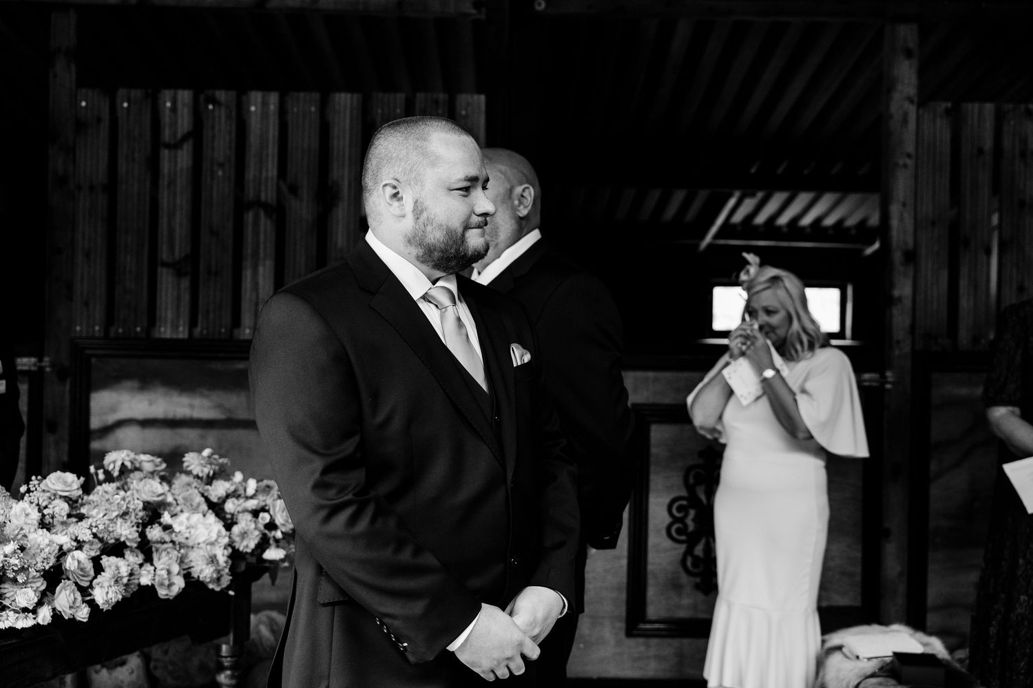 Black and white capture of emotional wedding ceremony moments.