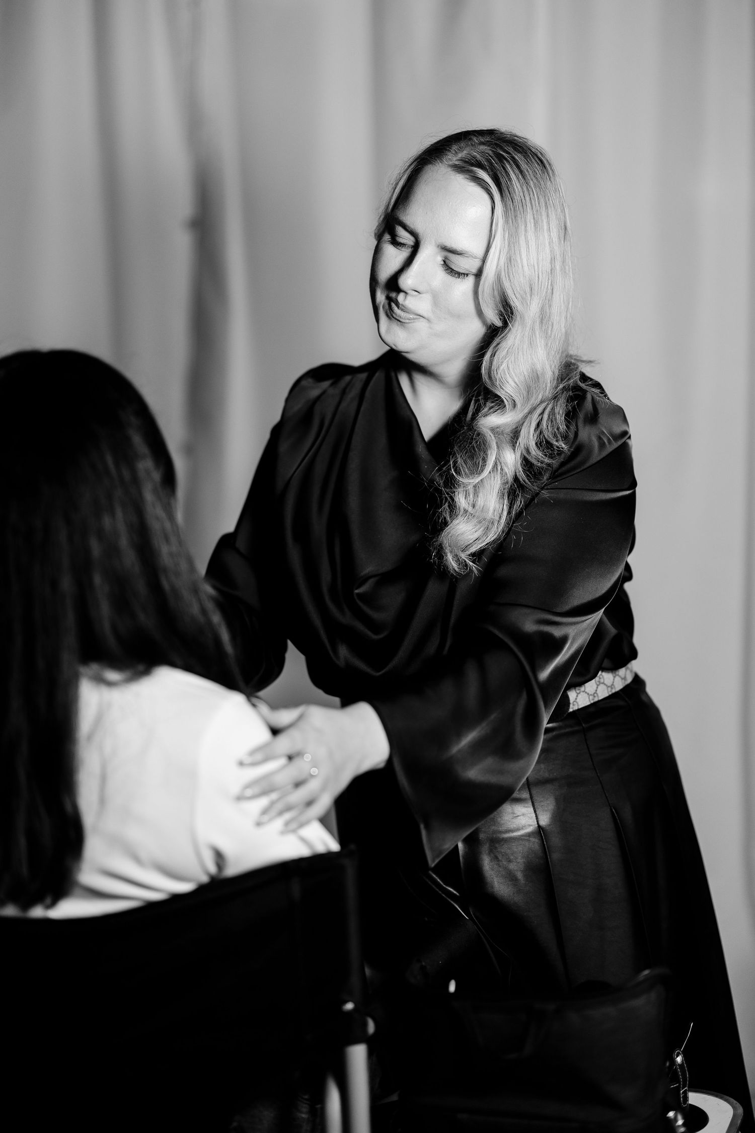 Dramatic black and white photoshoot with flowing black fabric.