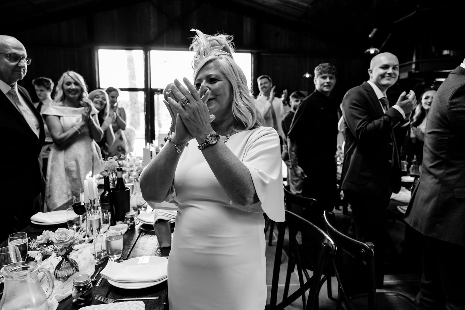 Wedding reception celebration with guests dancing and enjoying the festivities in black and white.