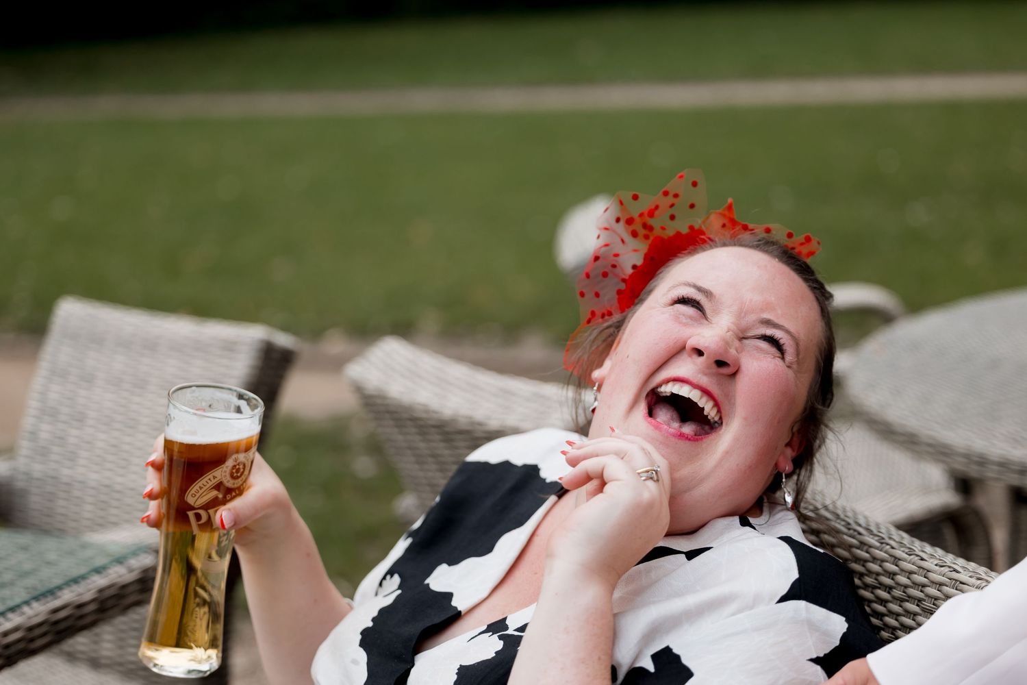 Candid outdoor shots of wedding guests enjoying drinks and laughter.