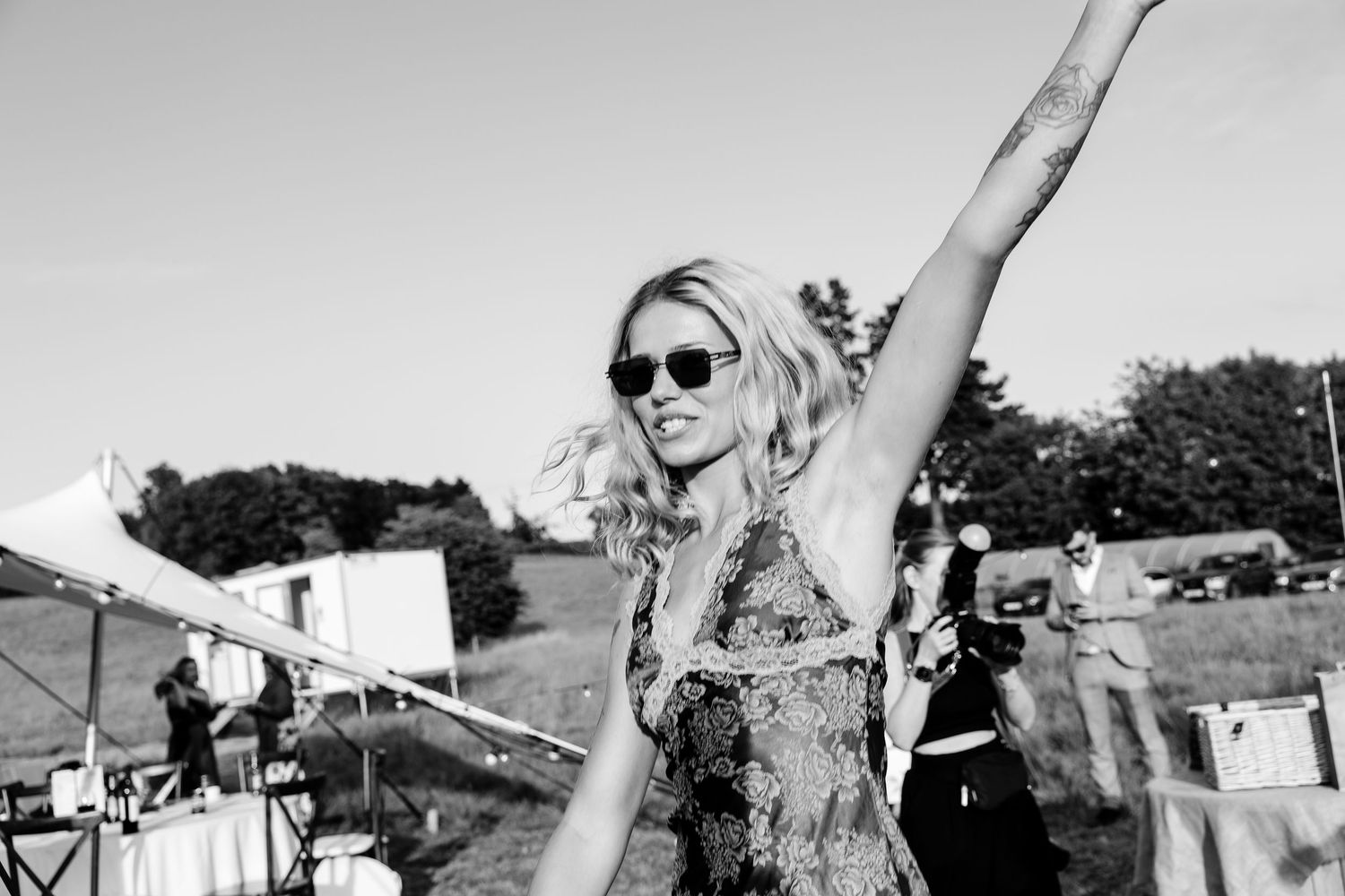Black and white photo of an enthusiastic guest celebrating at an outdoor event.