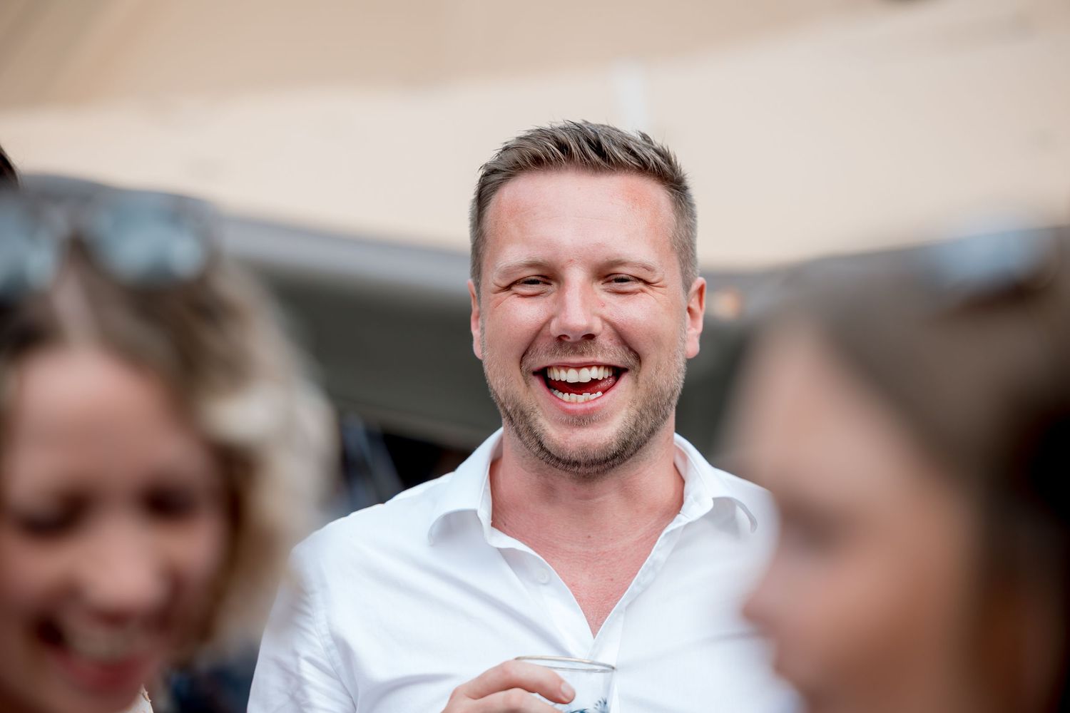 Wedding guests share joyful moments during the celebration.