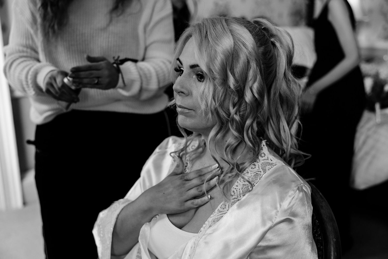 Black and white candid shots of wedding guests during emotional moments.