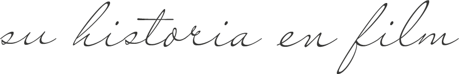 Handwritten text in cursive script appears on a white paper surface.