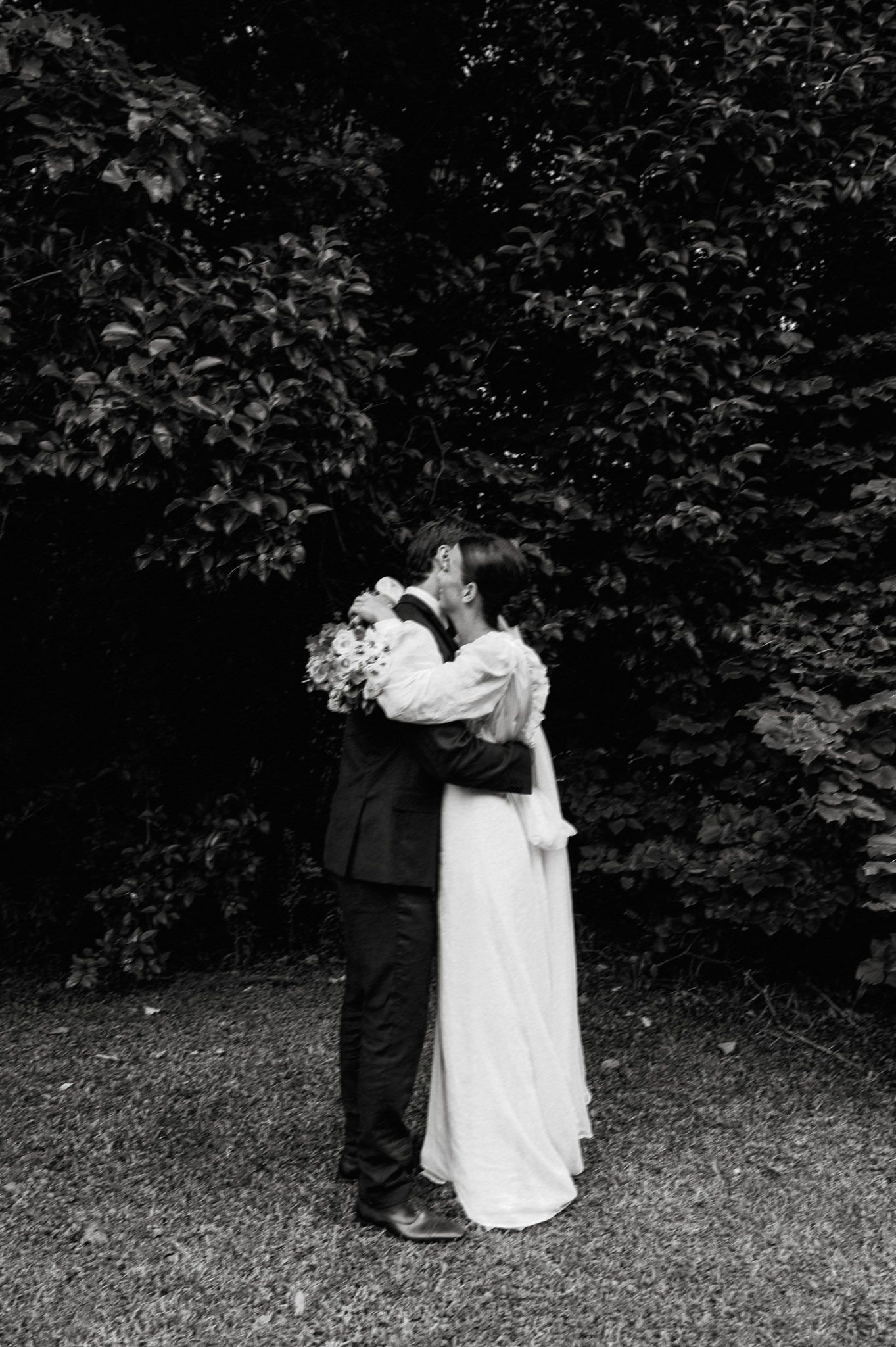 A romantic dance sequence in black and white showing emerging movement along a garden path.
