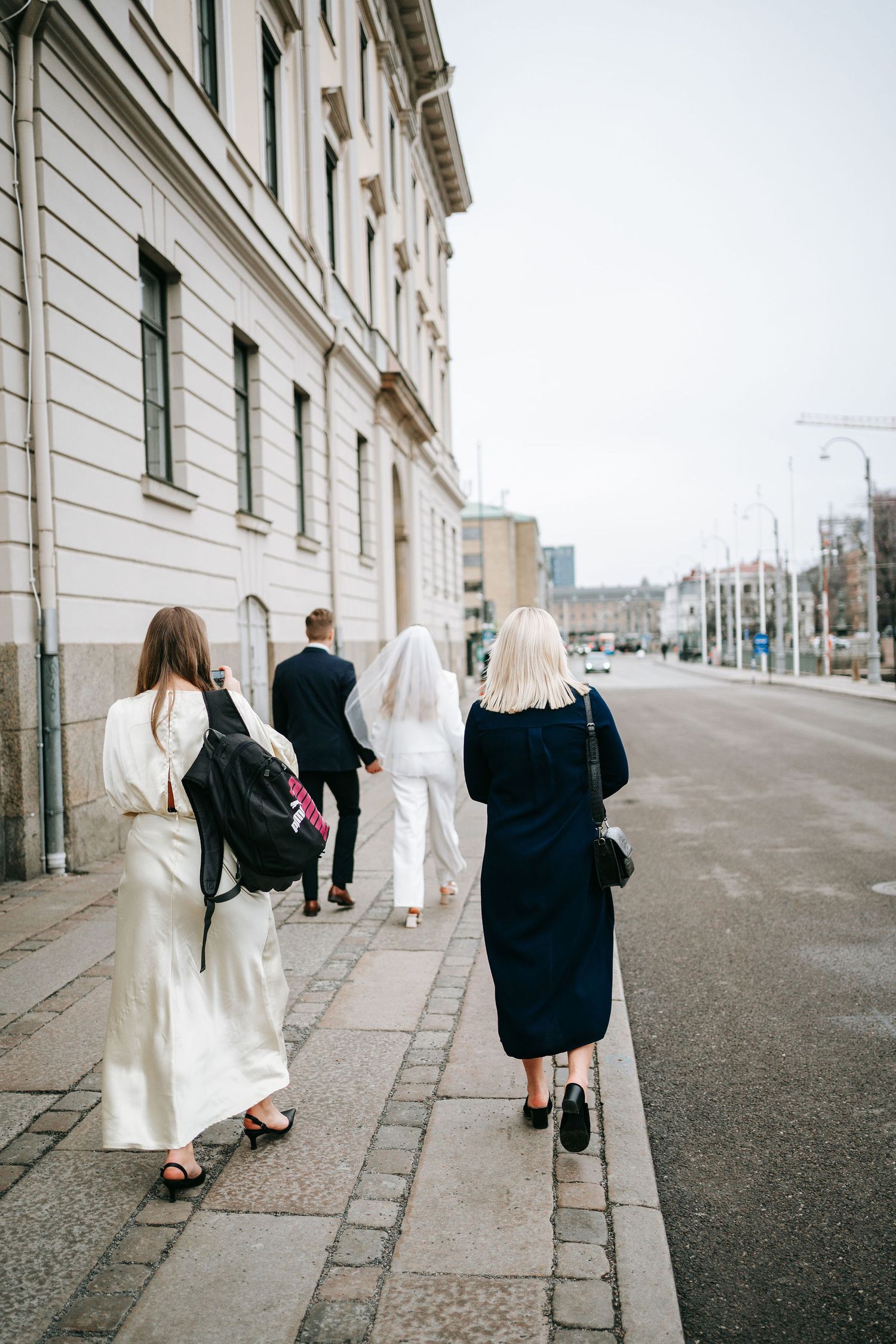brudföljet med brudparet och vittnen påväg till rådhuset i göteborg för vigsel. borglig vigsel göteborg fotograf