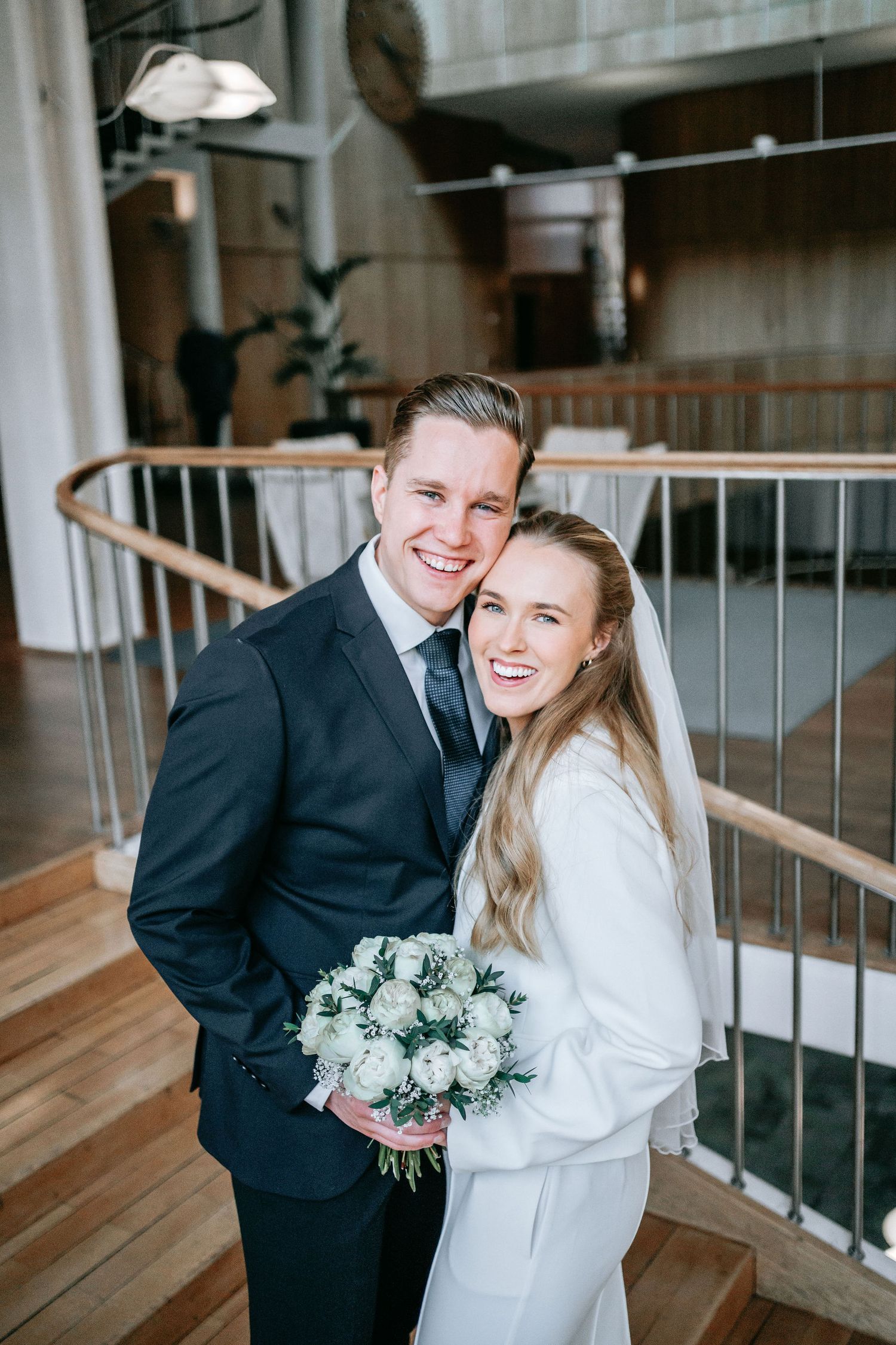 Lyckligt brudpar i trappan inomhus i rådhuset i Göteborg. vigsel fotograf göteborg