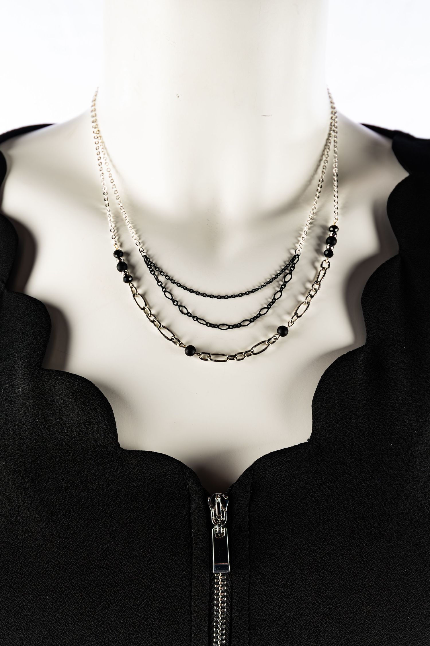 Image of necklaces featuring black and silver chains, also black pearls. Photos of products that a company will be selling on their website.