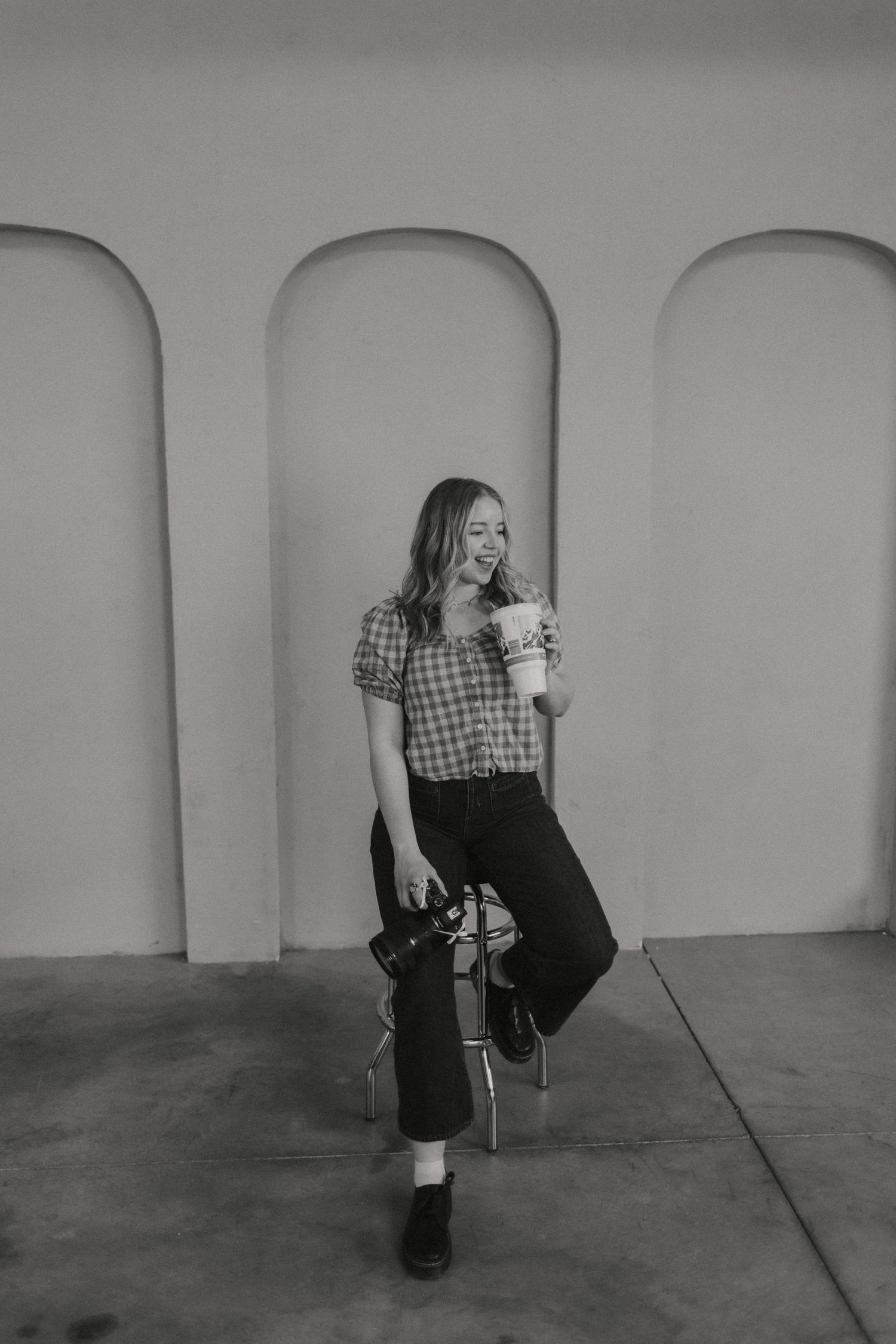 Black and white sequence of person in vintage clothing crouching on concrete floor.