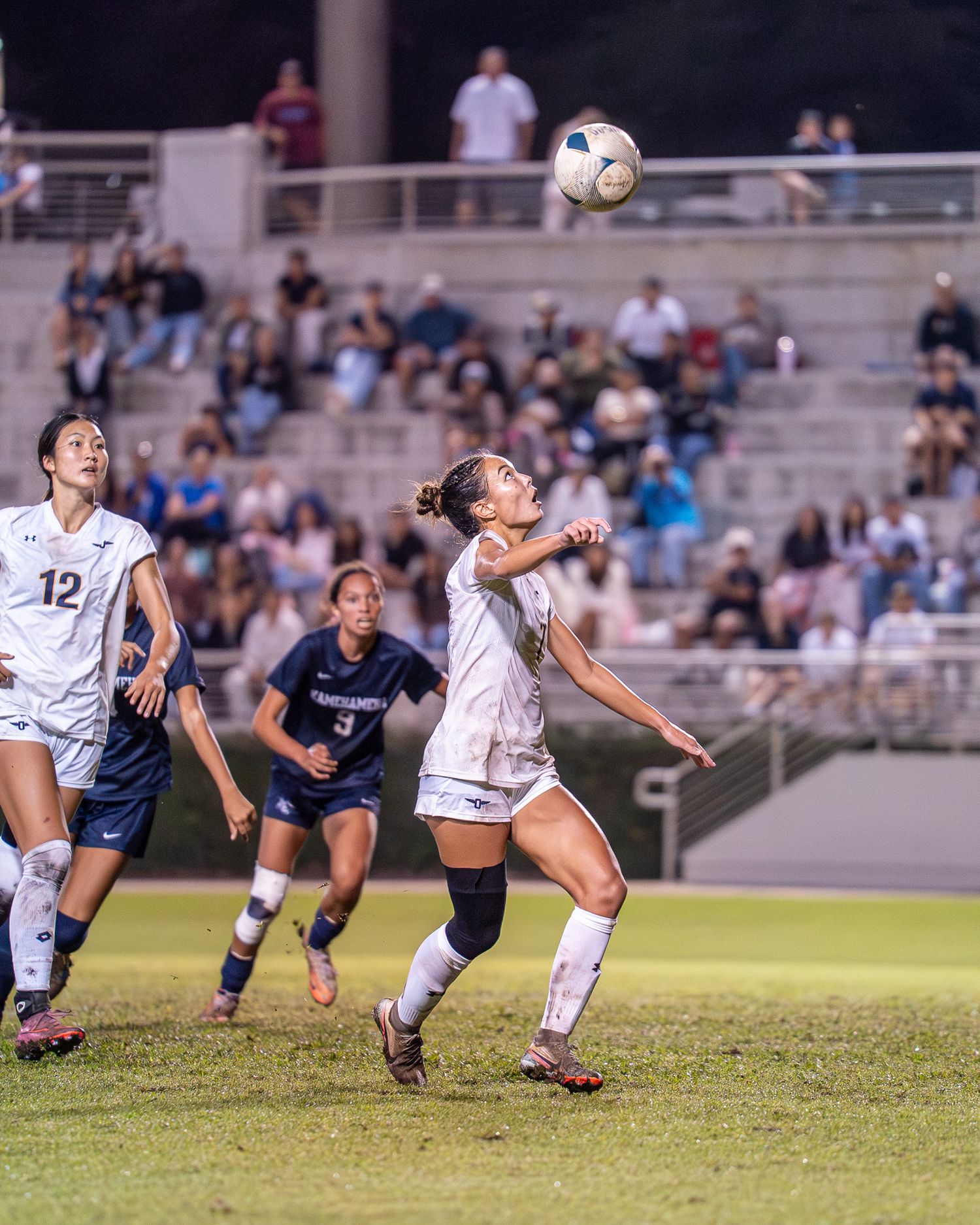 Soccer players competing for the ball in a fall season game