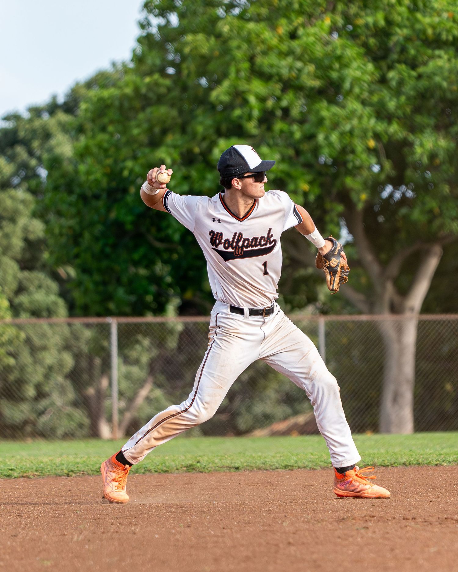 Baseball outfielder tracking a fly ball during a spring game in Hawaii