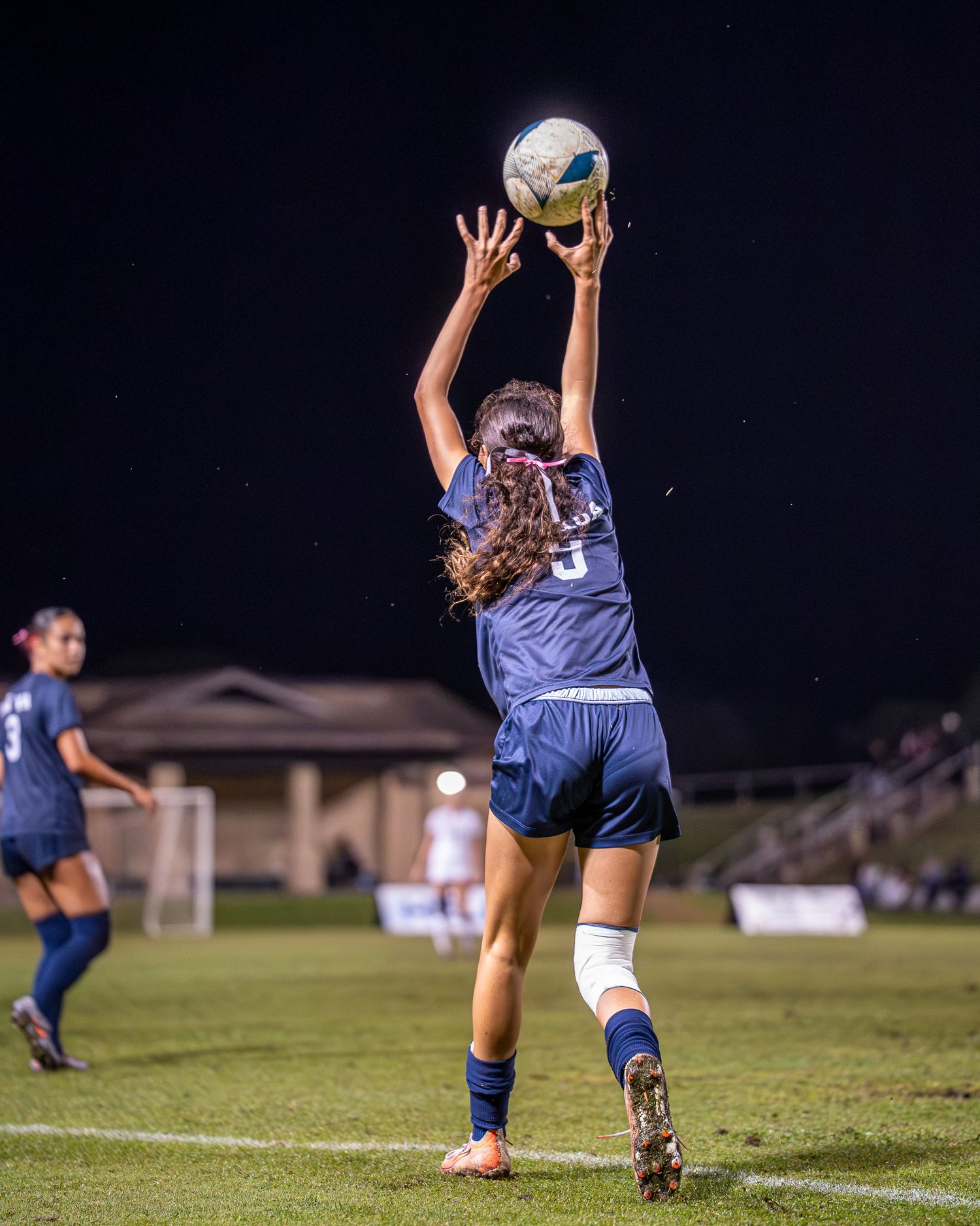 Soccer player dribbling during a fall season match in Hawaii