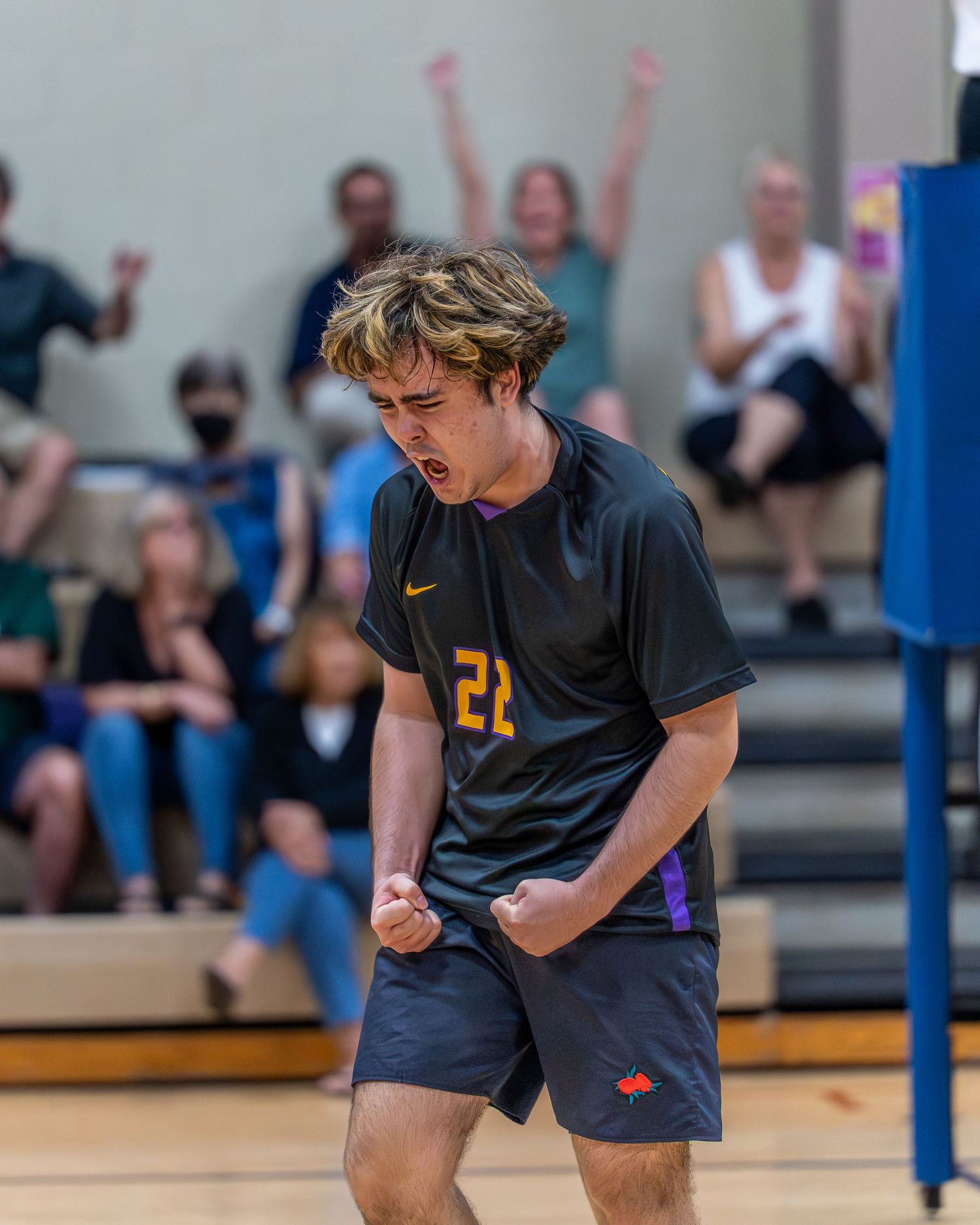 Volleyball team celebrating a point during a spring championship match