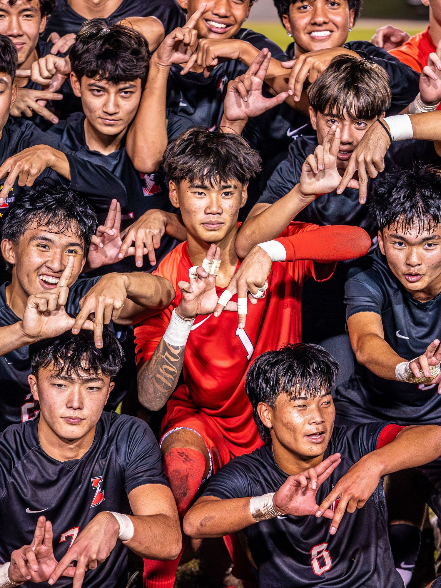 High school soccer player kicking the ball during a championship match
