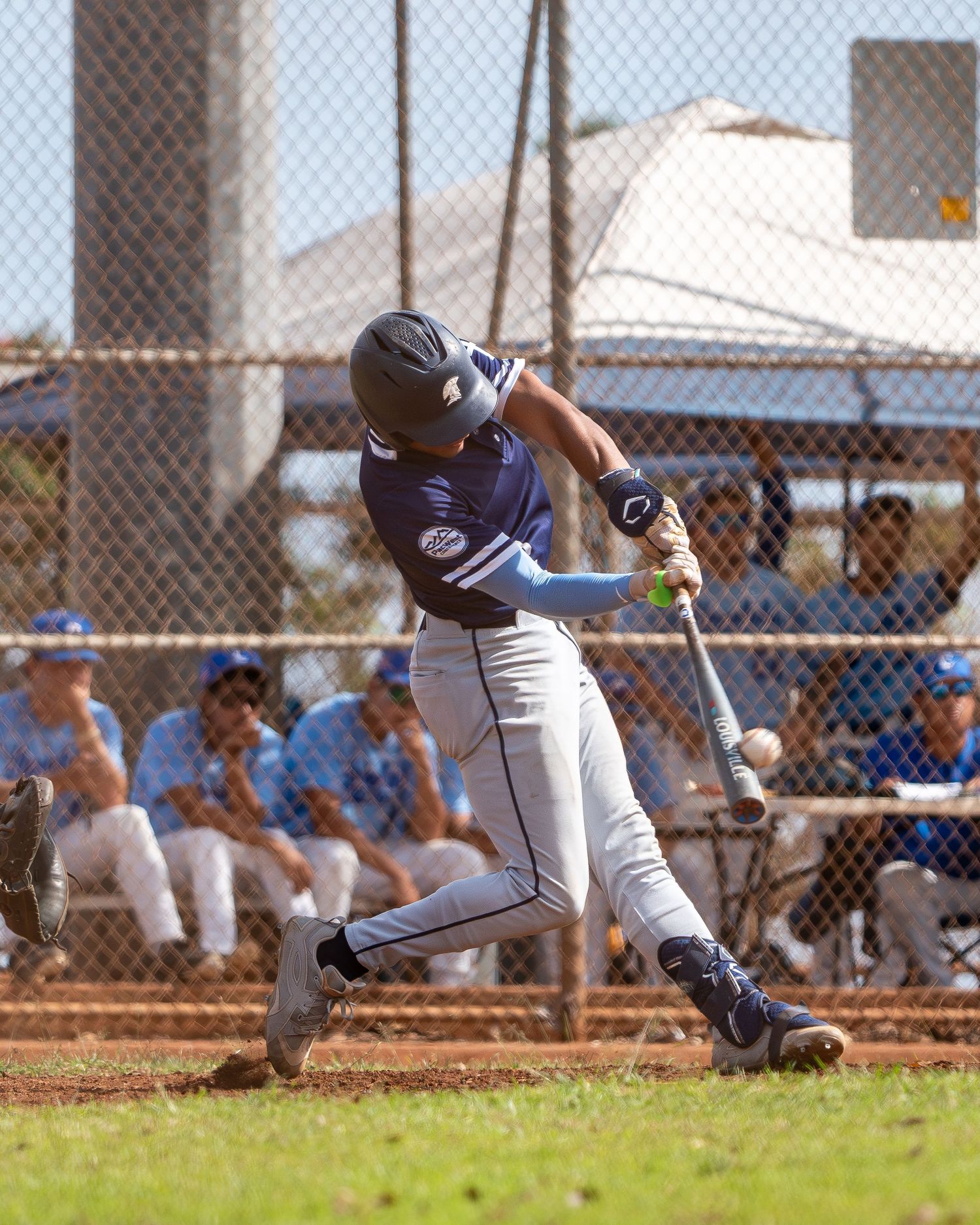 Baseball batter making contact at the plate in Hawaii