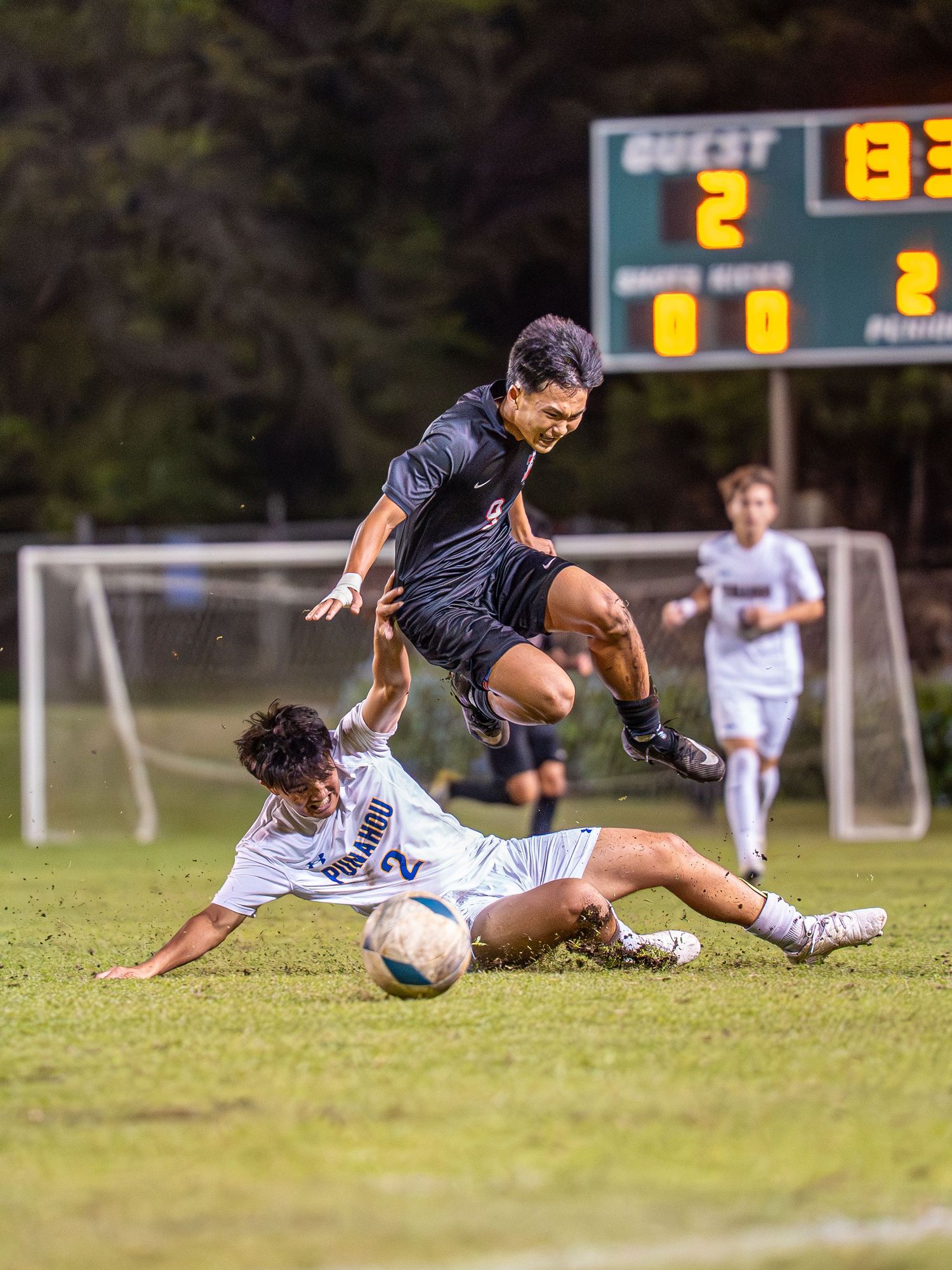 Soccer players in an aerial duel during Hawaii's fall soccer season