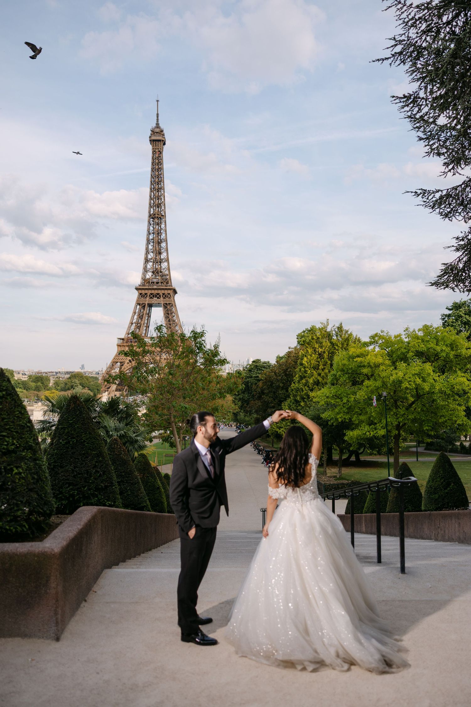 Couple portrait under the Eiffel Tower in Paris captured by wedding photographer Chris Cheilas