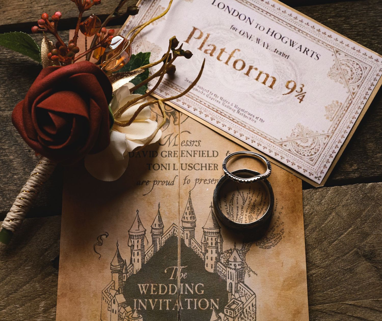 Harry Potter themed wedding invitation with Platform 9 3/4 ticket, wedding rings, and red rose bouquet.