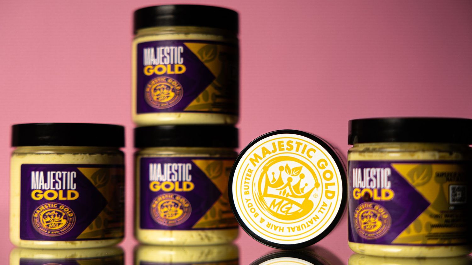 Purple and gold branded containers displayed against pink background with logo visible.