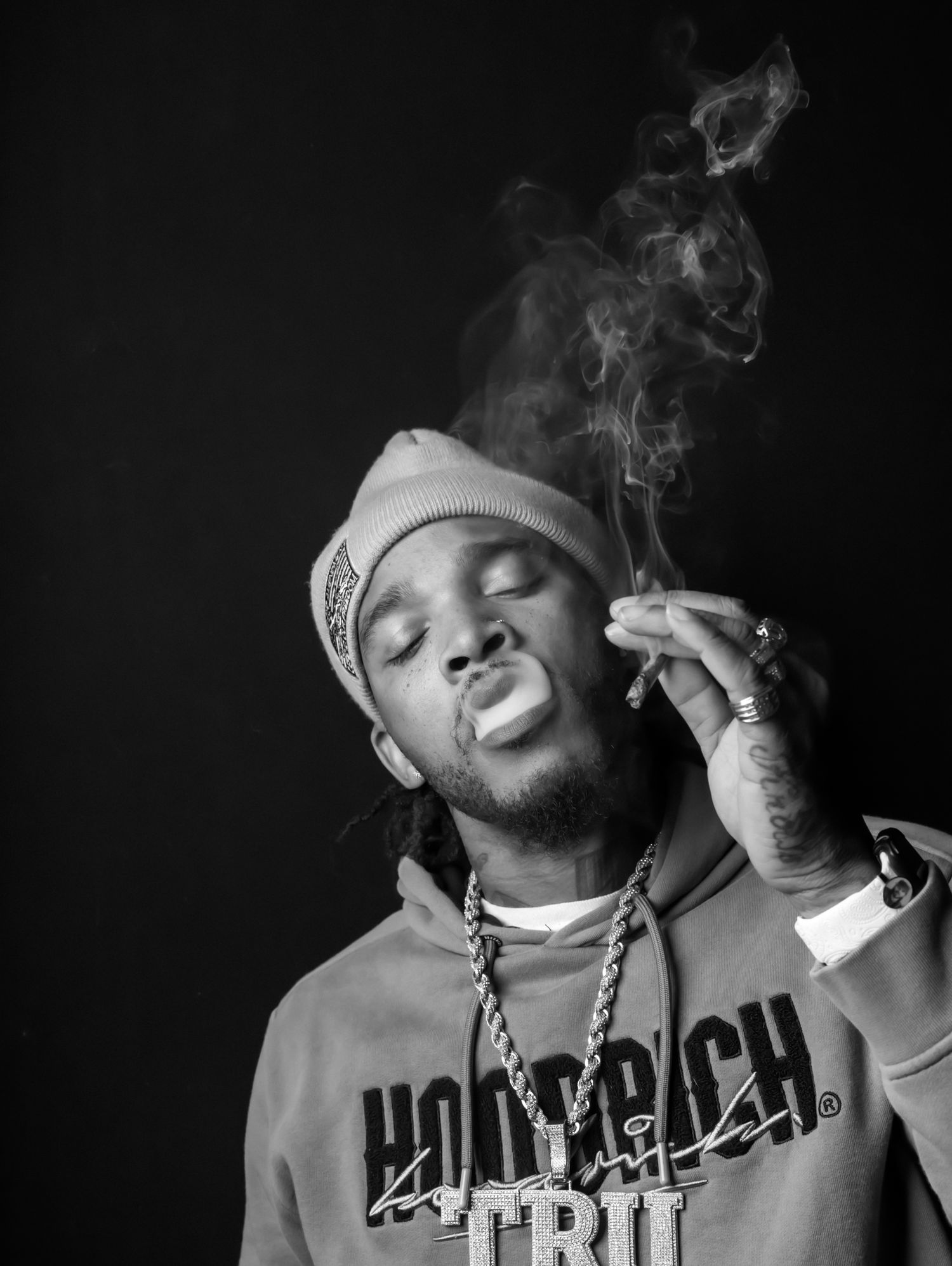 Dramatic black and white photos with smoke effects and urban style clothing.